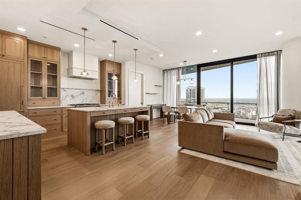 Extraordinary opportunity to experience elevated luxury living at Bleu Ciel. Perched on the 17th floor, this exceptional two-bedroom residence showcases expansive terraces, dramatic floor-to-ceiling glass, and breathtaking views. The completely reimagined kitchen is a show-stopper with custom cabinetry, sleek marble, premium appliances, and a stunning walk-in pantry, opening seamlessly to the sophisticated living and dining areas. Dual primary suites offer spa-inspired marble baths and oversized custom closets. A private balcony with fireplace provides the perfect setting to enjoy incredible views of the Dallas skyline. A chic powder bath completes the home. Residents enjoy world-class amenities including 24-hour concierge, resort-style pools, spa, fitness center, wine room, private garages, conference rooms, and valet parking, all in the heart of the vibrant Harwood District.