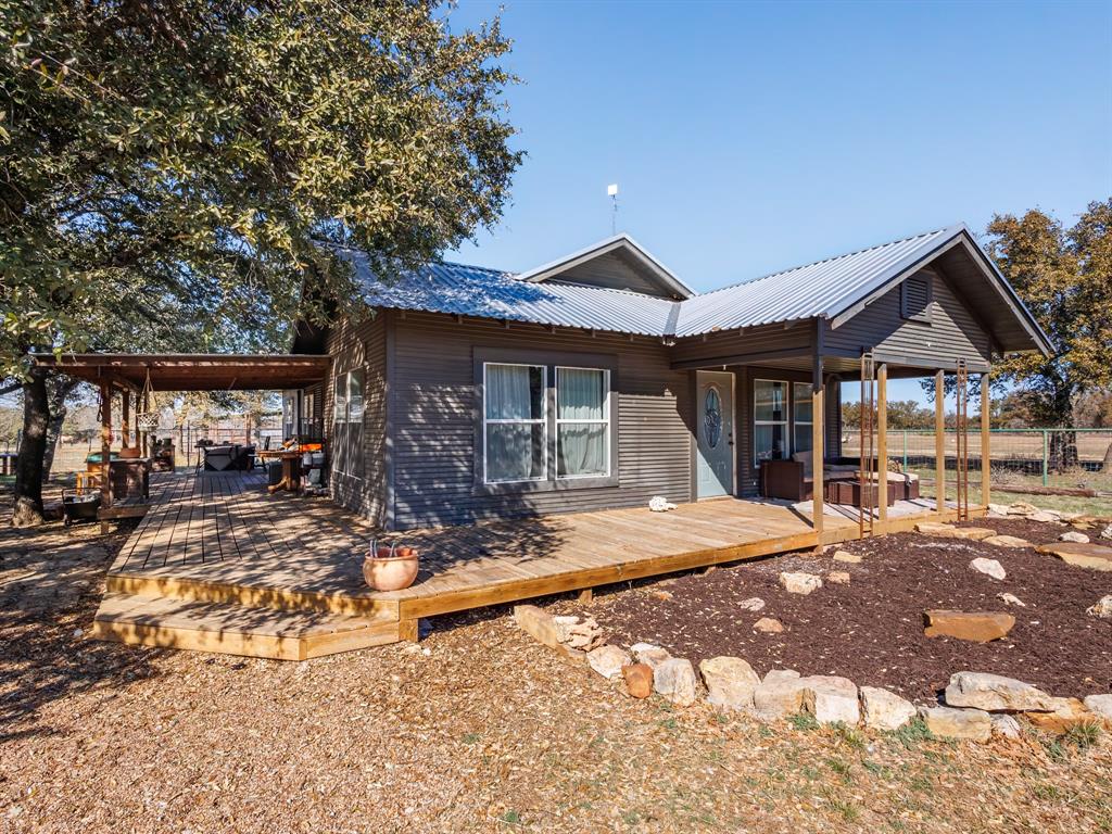 This property features 34 acres of land and includes a cozy 2-bedroom, 2-bath house that could easily be converted into a 3-bedroom home. The interior has a lot of beautiful wood on the walls instead of drywall, giving it a warm feel. It’s only an 11-minute drive to shopping in Brownwood. The land is fully fenced with barbed wire and has cross fencing. Located at the end of the road, it offers privacy with very few neighbors around.

The property features: New metal roof, less than two years.
Mini splits (heat and cool), less than two years old.
Propane tank, propane heat
Pole barn with electric and water 
Another small barn, with pen
Ag exempt
Newer double pane windows
Stone fire pit
In ground water irrigation boxes around house and barns(freeze protection)
Land cleared about five years ago of cedar and mesquite.