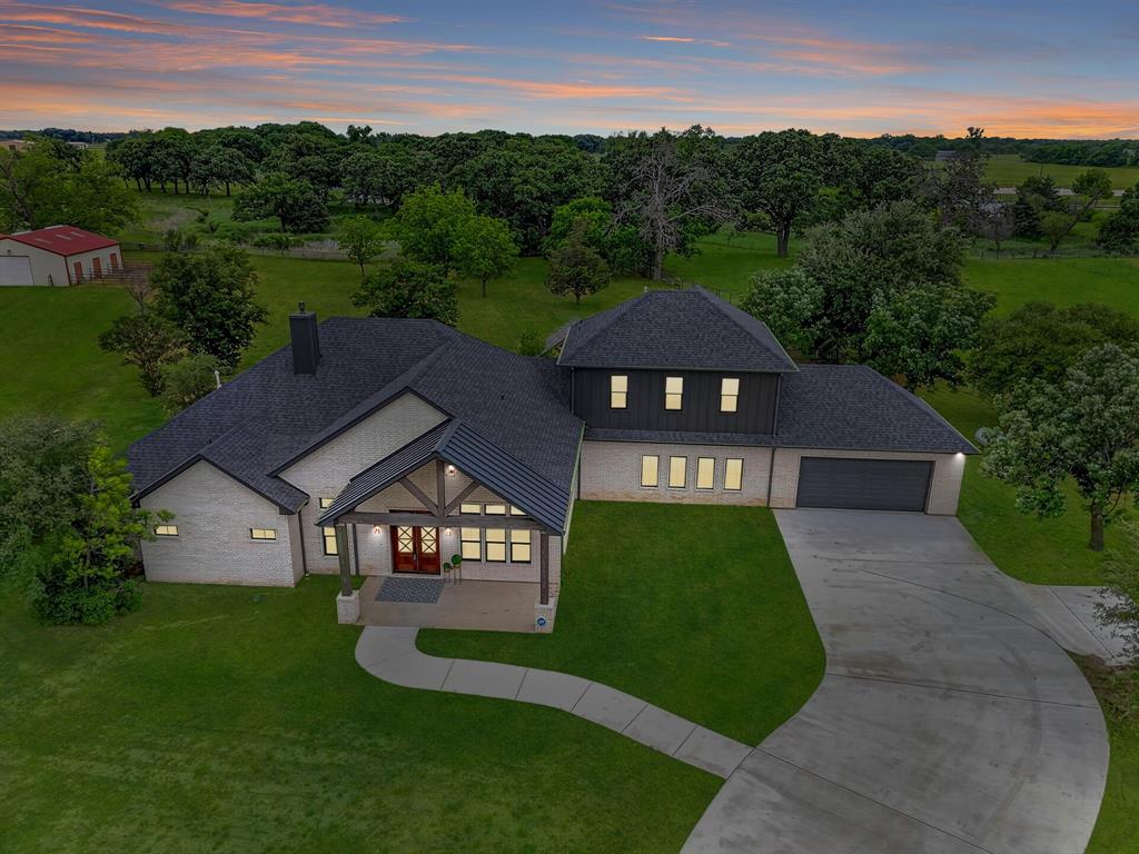 This one truly stands apart. Set on 5+ picturesque acres in a premier horse country location, this exceptional property has been completely taken down to the slab and thoughtfully rebuilt in 2024–2025. Offering the rare combination of modern luxury and timeless land appeal.
Inside, you’ll find a spacious and versatile layout featuring 4 bedrooms, 5 full bathrooms, 1 half bath, a private home office, and a media and flex room providing endless options for entertaining, multi-generational living, or work-from-home needs.
The heart of the home is a stunning, open-concept kitchen designed with today’s most sought-after finishes, including quartzite countertops and full backsplash, a built-in Thermidor smart refrigerator, a monogram gas and electric range, an oversized appliance pantry, and an expansive laundry room designed for both beauty and function.
Step outside and experience resort-style living. The property showcases a completely updated pool paired with an outdoor cabana featuring a wood-burning fireplace, creating the perfect setting for year-round entertaining and relaxing evenings under the stars.
Equestrian enthusiasts will appreciate the fully equipped setup, all secured behind a private electric gate. The acreage features a 3-stall barn with attached runs, tack room, feed room, storage space, and an equipment, trailer shed. The sandy loam soil is ideal for horses, with ample space to add a riding arena just beyond the barn. Mature 300+ year-old pecan trees add incredible character and shade, while a dedicated area offers the perfect opportunity to create a private garden retreat. The road into the property is possibly going to be paved in the near future. This home has only been occupied for approx. 2 weeks and is practically brand new. 
With room to roam, refined finishes throughout, and every detail carefully considered, this is a rare opportunity to own a fully reimagined estate in one of North Texas’ most desirable equestrian settings.