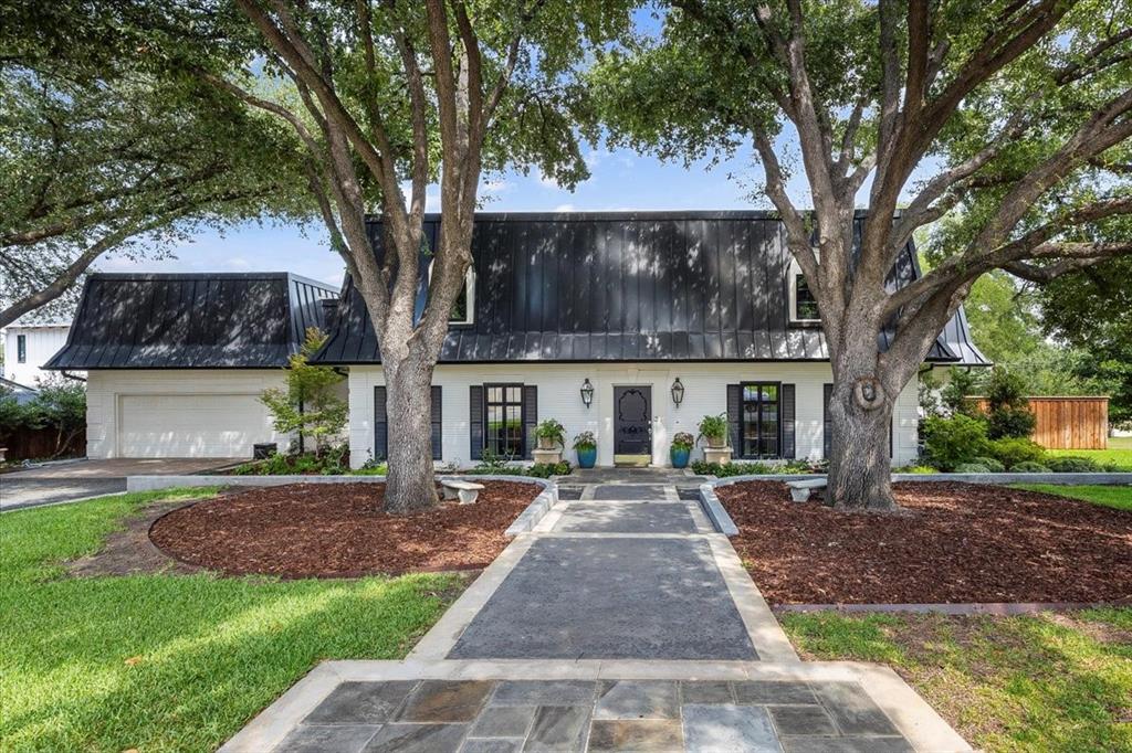 Situated on a spacious corner lot just under half an acre, this beautifully renovated two-story home offers 5,074 SF, including a 4,289 SF main residence and a private 785 SF guest cottage.
The main house was extensively remodeled in 2020 with all new HVAC, plumbing, electrical, PELLA windows, tankless water heaters, and a 2023 roof. The first floor features 9-ft ceilings, French oak hardwoods, travertine, marble, and designer finishes. The open-concept living area includes a Control4 smart home system and a 36” gas fireplace. The gourmet kitchen boasts a Sub-Zero refrigerator, Wolf 6-burner cooktop and double ovens, Bosch dishwasher, warming drawer, microwave drawer, wine fridge, oversized island, and coffee-dry bar. The home offers 5 bedrooms, including a luxurious first-floor primary suite with spa-inspired bath, plus a flexible fifth bedroom currently used as an additional living room.
Completed in 2020, the 785 SF guest cottage is ideal for multigenerational living, with a full kitchen, laundry, sitting room, bedroom, and accessible bath with curbless shower. Separate tankless water heater and HVAC service for guest house , American hickory hardwoods, PELLA windows, and custom window treatments make it move-in ready.
Additional highlights include a sprinkler system, underground drainage, buried electrical lines, mature trees, and new gutters with leaf guards. Zoned to Overton Park Elementary, this rare property combines neighborhood charm with the comfort and efficiency of a nearly new build.