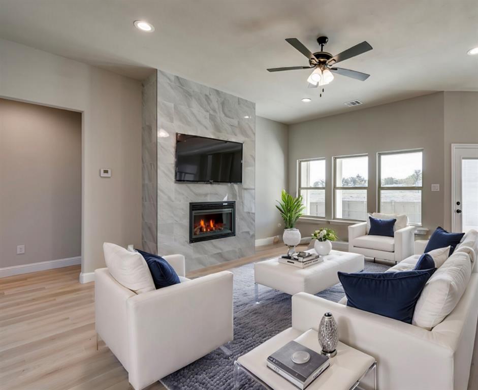 Country living in this stunning new construction home in Palmer, Texas. Designed with both everyday comfort and entertaining in mind, this spacious 4 to 5 bedroom, 3-full-bath home offers thoughtful design and stylish finishes throughout. The heart of the home is the gourmet kitchen in warm neutral colors, featuring a massive quartz island, striking custom cabinetry, designer backsplash, and a modern vent hood above the gas range—perfect for cooking, gathering, and hosting family and friends. The inviting living room is filled with abundant natural light and anchored by a sleek electric fireplace with blower and dramatic floor-to-ceiling tile surround, creating a warm and stylish focal point. Luxury vinyl flooring flows through the main living areas for durability and easy maintenance. The private primary suite offers a relaxing retreat with elegant shelf ceiling details, along with a spa-inspired ensuite bath featuring dual sinks, a soaking tub, and separate shower. Upstairs, there is a 5th bedroom with full bath & closet or can be a spacious game room, which provides the perfect hangout for teens, movie nights, or additional family living space. Located in the heart of Palmer ISD, one of the area’s most sought-after school districts, this home offers peaceful country living with the convenience of a short 35-minute commute to the Dallas-Fort Worth Metroplex. A must-see opportunity to enjoy modern style, space, and small-town charm. There are other homes available for tour in the Copper Penny Estates Subdivision.  Ask about Incentives