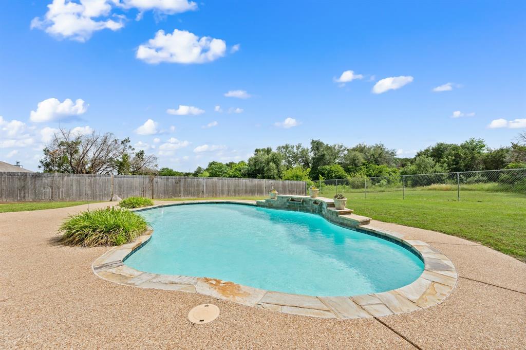 Located in the gated Indian Harbor subdivision, this 4 bedroom, 2 bathroom home offers a rare balance of privacy and community on a full 1 acre lot. The interior has been refreshed for a clean, move-in-ready feel. The four bedroom plus bonus room layout provides plenty of space, while the oversized detached 2 car garage offers significant room for a workshop, storage, or larger vehicles. The backyard serves as a private getaway with an in ground pool, providing a quiet space to cool off. Because the property sits on a full acre, you have the benefit of a spacious, open feel that is hard to find in many gated neighborhoods. It is a perfect setup for those who want their own land without sacrificing the security and social benefits of an established community. As part of the Indian Harbor HOA, residents enjoy a wide array of amenities that cater to an active lifestyle. You’ll have access to the community clubhouse, pool, teen center, and walking trails. For lake lovers, the neighborhood includes a private marina with a boat ramp and fishing pier, plus the convenience of the on-site Marina Café. This property is a great opportunity for anyone looking for a functional, updated home with plenty of outdoor space and lake access perks.