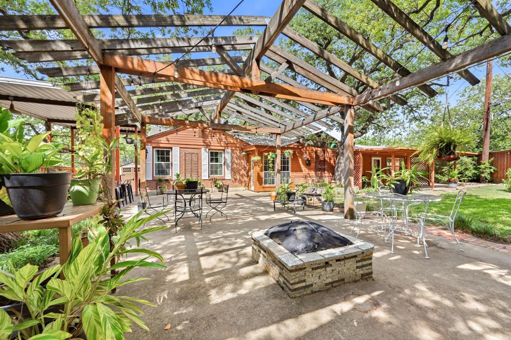 1948 ranch-style home on an oversized lot-and-a-half in Fort Worth's beloved Oakhurst. Unique outdoor features include an enormous backyard, mature landscaping, storage shed, 11 x 56 RV, boat, or extra vehicle parking area, and multiple entertaining spaces. Finally, enough room for your hobbies, your toys, and maybe even your guests! Inside, vintage character blends seamlessly with thoughtful modern updates. Original millwork, hardwood floors, stained-glass accent windows, an antique furniture vanity, penny-tile in sunroom, and period-inspired lighting create timeless appeal. The kitchen is a standout, designed and enjoyed by a professional chef, ideal whether preparing a holiday feast or perfecting grilled cheese. Features include vaulted beadboard ceilings, concrete and butcher block countertops, a 48-inch commercial-grade gas convection range with 6 burners plus grill and exterior ventilation, a counter-height breakfast island, butler's cabinet with beverage fridge, ledgestone backsplash, and stainless appliances. The sizeable living room and two massive bedrooms are complemented by four flexible spaces currently used as a dining room, breakfast area, office-den, and sunroom. These adaptable areas can easily serve as a bar, library, fitness room, music nook, guest quarters, or more living. In other words, this home is ready to keep up as life changes. A pet door and abundant garage, built-in, and closet storage add everyday convenience. Major updates include windows, ceiling fans, tankless water heater, condensing unit, paint, and June 2026 roof. Oakhurst is known for rolling hills, mature trees, skyline views, a neighborhood park, and convenient access to Trinity Trails, Downtown, Stockyards, Panther Island, and major thoroughfares. Listed on the National Register of Historic Places, yet the neighborhood has no strict city preservation requirements. There is also no mandatory HOA, rather a voluntary association focused on community, unification, beautification.