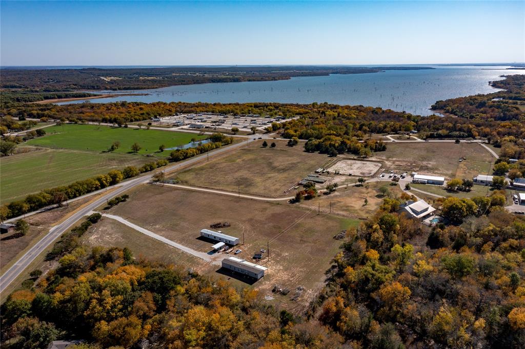 RARE FIND! This versatile 4.5-acre property offers two updated mobile homes, each with its own septic system and shared access to a private water well, making it an exceptional opportunity for buyers seeking space, privacy, and built-in rental potential. Both homes feature 3 bedrooms, 2 bathrooms, and open-concept living—one manufactured in 2021 with 1,200+ sq ft, the other offering 1,376 sq ft, quartz kitchen counters, and a cozy wood-burning fireplace. Enjoy expansive outdoor space, a secure electric entry gate, fenced yard areas, and plenty of additional unfenced acreage for recreation or future improvements. The land is partially designated for each home with remaining acreage as shared common space. With no water or sewer bills, peaceful surroundings, and close proximity to Lake Ray Roberts and I-35E, this property delivers convenience and country living in one package. Added bonus: the property already has 2 years of agricultural history through beekeeping toward a 5-year AG exemption—an incredible value for long-term tax savings. Located outside of the city limits. No city taxes! Opportunities like this rarely hit the market! Seller is also offering 7 acres with all improvements on the property at 550K if interested in more acreage.