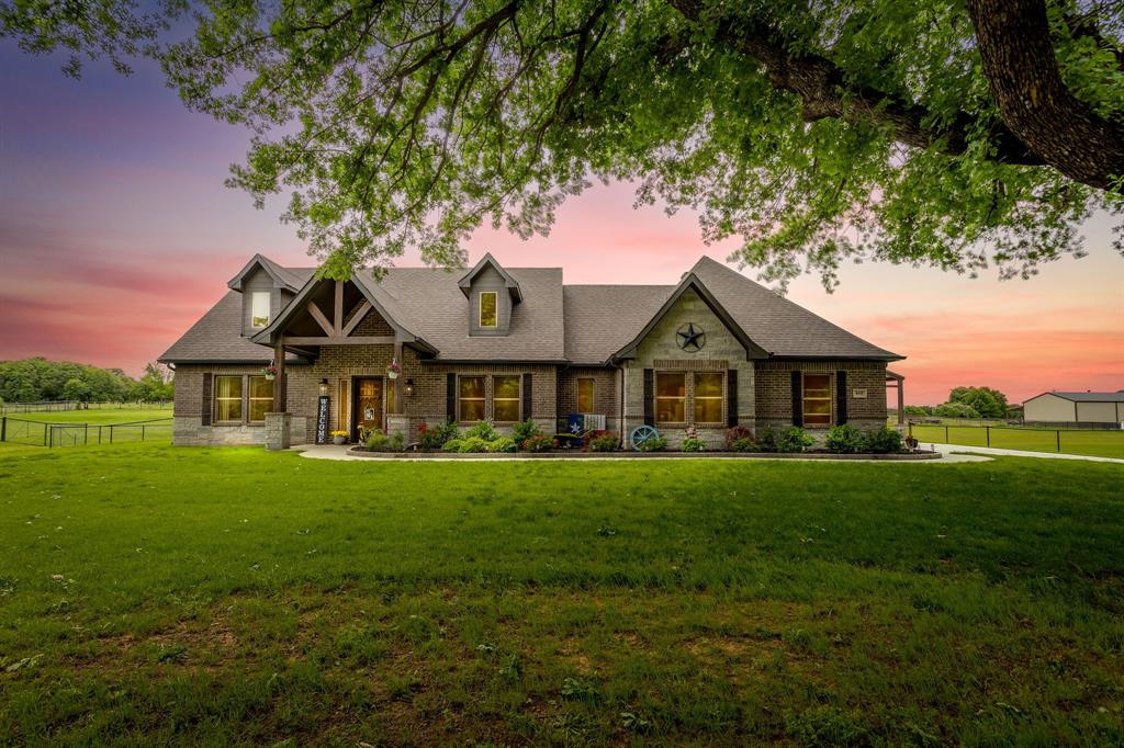 STUNNING HOME with 3 Bedroom, 2 Full Bath, 1 Half Bath & Bonus Room located in a PEACEFUL COUNTRY SETTING in Boyd, TX. Beautifully landscaped 1.25 ACRE property features a 2225 Sq Ft home and 24x30 WORKSHOP with electricity, foam insulation, 20x24 attached CARPORT, and 20x20 Lean to. From the moment you arrive, the CURB APPEAL grabs your attention with towering mature and manicured trees out front, to a masonry lined flower bed and sidewalk leading to the covered front porch. Inside find a home filled with warmth and comfort with LVP Flooring throughout. OPEN CONCEPT LAYOUT with wood burning FIRE PLACE, beautiful lighting, and windows framing your country setting backyard. Bonus room up front could be used as an office, additional living, or formal dining room. Extra HALF BATH is also a bonus feature for guests and everyday living. Kitchen features custom style cabinets, large island, quartz countertops, and stylish appliances. PRIMARY BEDROOM SUITE is generously sized with a LARGE WALK-IN SHOWER, dual sinks and large WALK IN CLOSET. Extra large utility room with built in cabinets and room for extra refrigerator or freezer. Enjoy peaceful relaxation listening to the birds singing on the covered back patio while overlooking your fenced-in property. EXTENSIVE UPGRADES and added features including fencing, landscaping, shop, concrete, paint, and more! Come view in person to capture the true essence and feeling of this exceptional home!