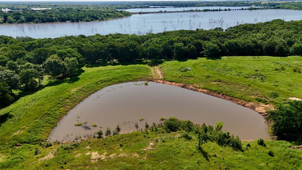 'NESTLED ALONG THE BREATHTAKING SHORES OF LAKE RAY ROBERTS, DISCOVER THE UNPARALLED POTENTIAL OF THIS STUNNING 12.851-ACRE EXCEPTIONAL WATERFRONT TRACT OFFERING AN UNMATCHED BLEND OF NATURAL BEAUTY, PRIVACY, & RECREATIONAL OPPORTUNITIES'...This Expansive Parcel Provides Great Access To One of Texas' Fishing Destinations Renowned For Its Trophy Bass, Catfish, Crappie, & Perch * With Remarkable Expansive Lake Views Perched On the Water's Edge, Picturesque Rolling Terrain, & Vibrant Texas Sunrises As Your Backdrop, This Amazing Property Is Rich in Character, Framed By A Beautiful Private Stocked Fishing Pond, Mix of Established Century-Old Pecan & Oak Trees, Desirable Sandy Loam, Improved, Lush Coastal Pastures, & Private Road * Creating An Inviting Atmosphere Perfectly Suited for Agricultural Ventures Or For Those Looking to Raise Horses & Livestock & Offering Several Building Sites For Your Dream Ranch Home Or Weekend Getaway * Thriving Area Combines The Allure of Rural Living w-Convenient Access to Urban Amenities * Located Less Than 45 Minutes from DFW & Just Minutes Away From Historic Charming Tioga, Pilot Point & Future Route of N Toll Rd Outer Loop, The Location Is Poised for Continued Appreciation * Surround Yourself w-Breathtaking Horse Ranches & Expansive Acreage Estates In A Community That Embraces True Essence of Texas * Explore The Natural Beauty of Johnson Branch State Park & Indulge In Outdoor Adventures Such As Fishing, Hiking, Biking, Horseback Riding, & Boating, Making This Property A Perfect 'Slice of Heavenly Haven' For Nature Lovers & Those Seeking An Authentic Western Lifestyle*Don't Miss This Exceptional Opportunity To Own Your Own Piece of North Texas & Create Your Own Paradise*To Maintain the Land's Integrity, Property Is Lightly Deed Restricted*No City Taxes*Ag Exemption Offers Lower Property Taxes * Woodbine Water & PenTex Electric Available w-Access for Water Meter *Top-Rated Callisburg Schools or Tioga Open Enrollment*Add'l Land Available