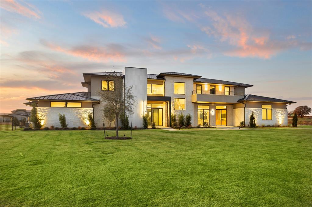 Positioned to sell — bring your clients’ best proposals. Set on two private, fully landscaped acres, this exceptional Bartonville estate blends quiet luxury, architectural craftsmanship, and modern convenience. Offering 10,420 SF under roof (6,977 SF air-conditioned) with five garage bays, the home provides rare privacy while remaining close to all that Bartonville offers, including highly rated Argyle ISD and proximity to Liberty Christian School.
A striking iron-and-glass entry, Class 4 standing seam metal roof, and expansive Andersen and Western windows create a timeless exterior and light-filled interiors. The backyard is a true retreat with a resort-style pool and spa, water features, concrete pavers, mature trees, full irrigation, and black iron fencing.
Two covered outdoor living areas are designed for year-round enjoyment—one with a gas fireplace, heaters, and TV, and the other a fully equipped outdoor kitchen with premium appliances and Phantom screens.
Inside, refined finishes include 5” white oak hardwoods, honed stone columns, Level 5 smooth drywall, 8’ solid-core doors, custom cabinetry, quartzite and quartz countertops, and layered LED lighting. The private primary suite features a coffee bar, dual custom closets, and a spa-level bath. Four additional en-suite bedrooms, a family room with gas fireplace, dining space, leisure-wine room, game and theater room, office, and gym complete the thoughtful layout. A smoked-glass residential elevator offers seamless access. 
The home is enhanced by Sub-Zero-Wolf appliances, Control4 automation, Lutron lighting, whole-home audio, advanced security, foam encapsulation, multistage HVAC, and tankless water heaters—delivering understated luxury, comfort, and effortless living in one of Bartonville’s most coveted settings.  Guest suite is large enough to be second primary and elevator to second floor.