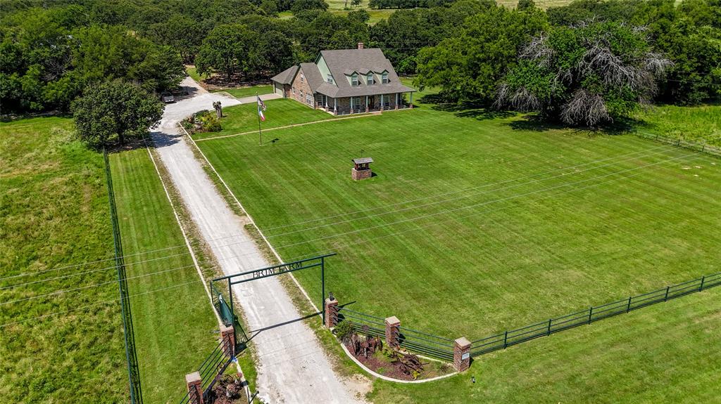 If you’ve been dreaming of wide open spaces and a slower pace of life, this is the place to make it happen. Nestled on 66 beautiful acres, this well-cared-for custom home offers the best of country living. With 3 stocked tanks full of catfish, abundant wildlife, and a layout that’s perfect for both everyday living and big gatherings, it’s no wonder this property is known as one of the most desirable in the area.

The home features 4 spacious bedrooms, including a private owner’s retreat downstairs, plus a dedicated office, three living areas, and a kitchen any home cook will love. From the quality woodwork throughout to the thoughtful layout, this home was built to last and built for comfort.

Step outside and you’ll find even more space to enjoy — an extended back patio for relaxing or grilling out, plus a party barn just a short walk away. It’s wired with electricity, has a half bath and industrial sink, and is the perfect spot for hosting reunions, weddings, or weekend get-togethers. There’s also a functional barn with working pens and a drive-through workshop with doors on both ends — ideal for horses, cattle, or farm equipment.

Whether you're looking for a weekend escape or a full-time homestead, this place has everything you need to enjoy the quiet, country lifestyle — all from the comfort of a front or back porch built for soaking it all in.