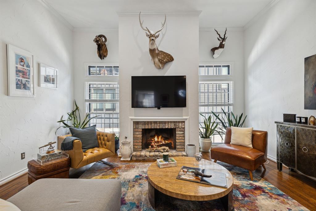 This impressive townhome is perfectly situated in the heart of Uptown area of Dallas, offering a fantastic location and a plethora of desirable features. Move-in ready condition and close proximity to Highland Park and Downtown Dallas, this home is truly a great find! The high ceilings and wonderful windows create a bright and airy atmosphere, complemented by an abundance of natural light. The rich hardwood floors add warmth and charm. The kitchen is equipped with stainless steel appliances, granite countertops, and a large bay window. The spacious living room features a cozy gas fireplace, while the loft like dedicated workspace adds another advantage to this gem. The downstairs area includes two bedrooms that share a Jack and Jill bathroom, and one of the bedrooms has an attached private patio area. Parking is first come first serve with a carport in front with 3 covered spaces and 2 open spaces with an additional 3 car garage in the back.  Walk to Whole Foods or Bob's Steakhouse!