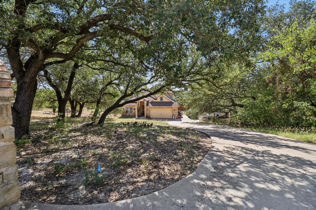 Welcome home to this beautiful one owner home located on just over a half acre in the highly sought after community of Indian Harbor! Located on a private and peaceful cul de sac, this home is only a short walking distance to the community pool and community center. 3 bedrooms, 2 full baths, downstairs living room, upstairs game room with a remarkable walk out covered balcony, and a private media room to watch the latest movies! Built in 2015 this home features 2253 square feet and only 1 owner since construction. Inside this home on the first level you will find the ultimate in functionality! Large open living room features a warm and inviting stone wood burning fireplace and etched concrete flooring. Functional kitchen with granite countertops, a breakfast bar, full appliances, walk in pantry, and a cozy breakfast area just off the kitchen with great views out to the backyard. Full size utility room just off the garage offers room for a full size washer and dryer. Large master bedroom with ample natural light offers plenty of space for your king size bed! Master bathroom offers granite countertops, garden tub, separate walk in shower, double sinks, and his and hers closets! Bedrooms 2 and 3 are spacious split bedrooms with walk in closets. Guest bath features granite countertops. All first level rooms feature beautiful stained and etched concrete flooring. Upstairs you will find your happy place! Large game room with a covered walk out balcony perfect for entertaining  and playing pool with the friends. Finished playing pool? Step into the large and quiet media room and catch the latest movies with your friends or family! Upstairs balcony offers plenty of room for sitting and overlooking the backyard and numerous trees. Outside you will find an extended driveway, extra large side and backyard, 2 car garage, sprinkler system, covered front porch, and a large covered back porch for sitting and relaxing. Wood privacy fence around back yard. Separate fenced dog run.