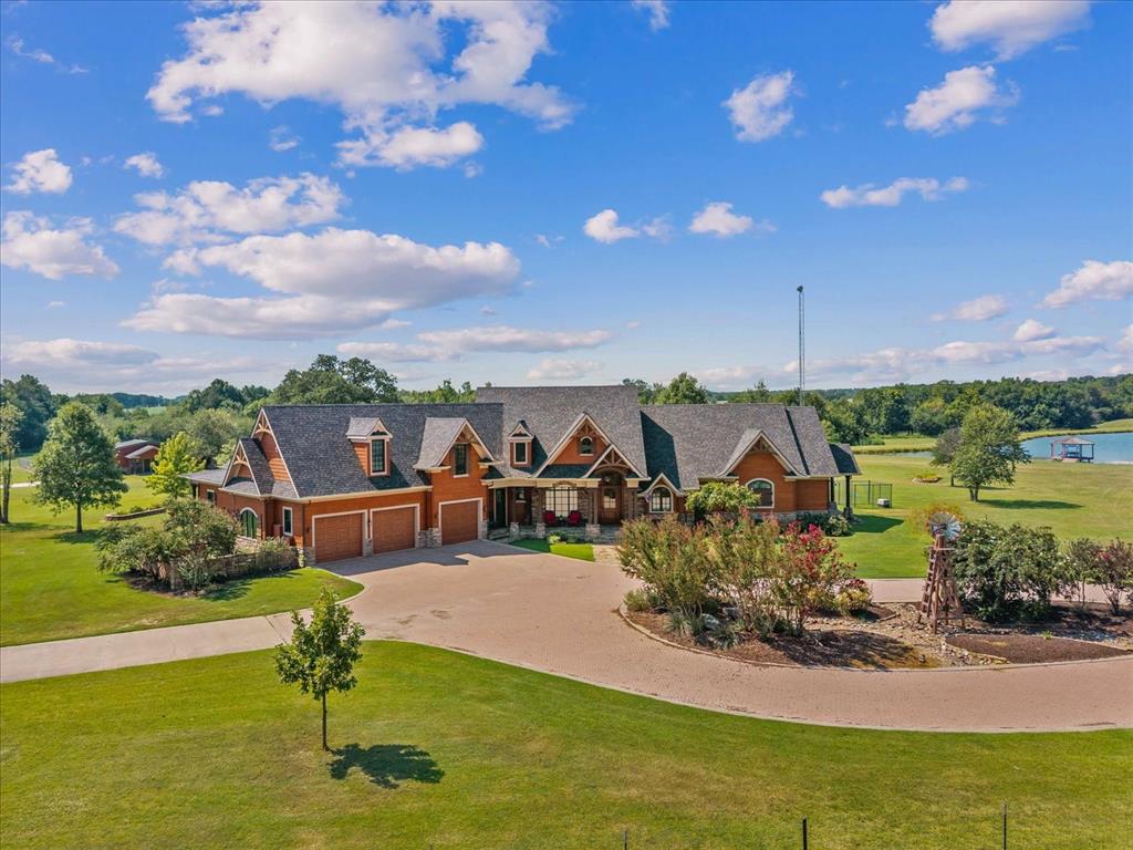 Luxury meets country living on this approx. 44-acre Honey Grove ranch estate! Over 7,500sq ft custom-built home offers 5 bedrooms, 5.5 baths, 2 full kitchens, and 4 living areas—perfect for multi-generational living or guests. Enjoy indoor comfort with, propane fireplaces, industrial gas cooktop, and hot-water heaters. Enjoy the indoor heated endless swimming pool with attached workout room, bedroom or step outside to beautiful fenced and cross-fenced pastures overlooking a stocked fishing pond with covered dock. Additional features include air-conditioned kennels and multiple outbuildings. Private apartment offers its own upscale amenities. High-fence security and pasture divisions make it ideal for animals or recreation. A rare combination of luxury, privacy, and Texas ranch living—just minutes from Paris and Bonham! This home leaves nothing out. Owners thought of everything to make this perfect for luxury living and a ranch. Everything is in place for raising all types of animals. Home has triple cable post tension engineered slab.