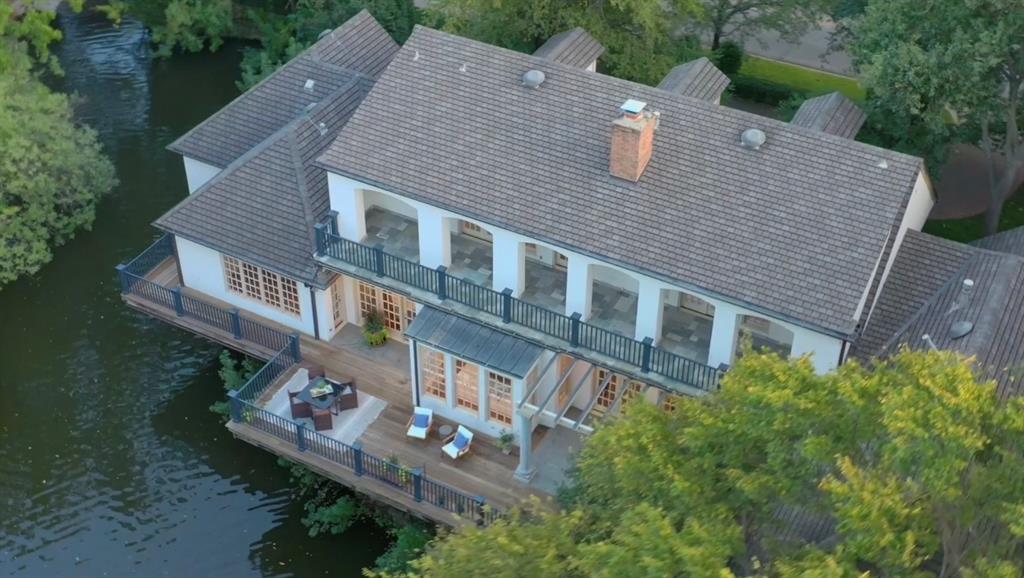Located on the exclusive enclave known within the community as the Culture Gulch. Custom designed by Richard Drummond Davis, the zero-lot design is low maintenance with high-quality construction. Living areas & master suite all reside on one level. 2 expansive terraces cantilever over the lake provide multiple areas to enjoy nature. Floorplan has great flow for entertaining. Primary suite has two separate marble baths & walk-in closets. 2nd bedroom down could serve as a game room or exercise room. Paneled library-study is handsome & enhanced by a fireplace. Across the street from Curtis Park, UP Pool, tennis courts, space to play with Kids & Dogs. A special place to call home in the heart of University Park!