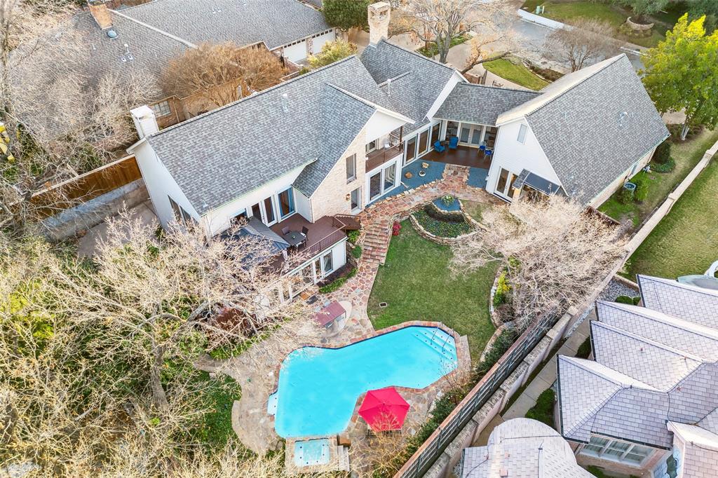 Situated on a beautifully landscaped sloping lot on a secluded cul-de-sac, this tranquil home offers a private location and a refreshingly unique design on four levels. Striking yet unassuming from the street, the interior of the house has expansive interiors and fantastic back yard. Walls of windows from nearly every room allow for tons of natural light plus fantastic views of the incredible, multi-level, park-like back yard. Lush landscaping and towering trees frame the outdoor paradise complete with covered porch, covered upper deck area, a grassy lawn and sparkling pool. The back yard is devoid of power lines and is 100% private every day of the year. The comfortable interior features 4,532 square feet of space with 4 bedrooms, 4 full bathrooms, 2 living areas, 2 dining areas, a handsome study, and a 2-car attached garage. High ceilings, abundant natural light, hardwood floors, marble countertops, custom millwork, and many other features are highlights of this exceptional home.