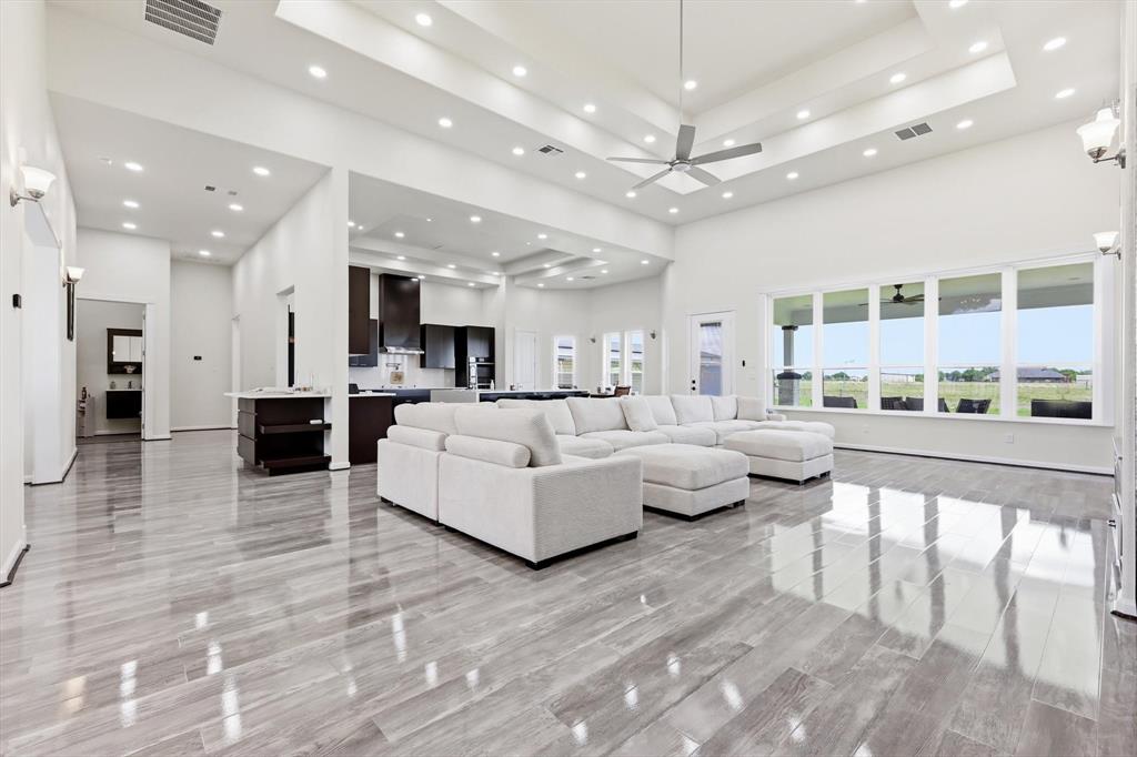 **Price Improvement** Hard-to-find One story estate home offering the perfect blend of luxury, comfort, & convenience, just off Hwy 78 & FM 205, with easy access to Plano.  Set on 2.47 private acres with your own fishing pond, this beautifully crafted custom home features 3-3.5- 7 Car + Study + Dining + a Separate In-Law Suite, ideal for multi-generational living or hosting guests in style. From the moment you arrive, the home makes a lasting impression with its striking brick & stucco elevation and charming circular driveway. Inside, you’re welcomed by an open concept design highlighted by vaulted ceilings, LVP wood flooring, & walls of windows that flood the home with natural light.  The expansive family room flows into a chef’s kitchen designed to impress, featuring an oversized quartz waterfall island, custom backsplash, & WiFi-enabled appliances, perfect for both everyday living and entertaining.
This thoughtfully designed layout includes two luxurious primary suites plus an additional bedroom with a private ensuite, all arranged in a split bedroom floor plan for maximum privacy. The main primary retreat offers a relaxing sitting area and a spa-inspired bath with a large walk-in shower, dual vanities, & an oversized walk-in closet.  Beyond the main home, the property truly shines with a 30x50 insulated garage(shop) capable of housing up to 4 additional vehicles. Attached is a beautifully appointed private in-law suite complete with a full kit, bed, bath, & its own outdoor kitchen with an extended covered patio, perfect for extended family or guests.
Step outside and unwind by your private fishing pond, creating a peaceful backdrop for relaxing evenings and unforgettable gatherings.
Offering the best of both worlds, this exceptional estate delivers serene country living with modern convenience, plus the added benefits of a low HOA and no city taxes. This is more than a home, it’s a lifestyle. Don’t miss the opportunity to make it yours.