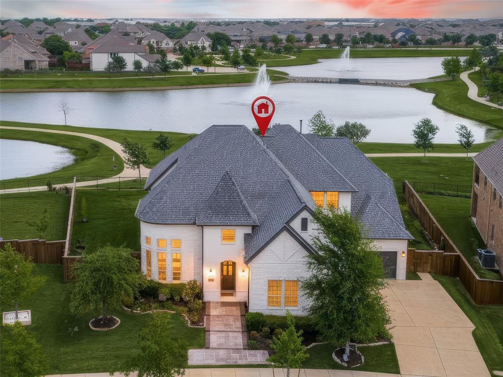 Experience the perfect harmony of luxury & innovation in this meticulously maintained home. Every detail of this 4,575-square foot home has been curated for comfort, security,& high end entertainment, situated on a premium 0.31 acre interior lot you will enjoy spectacular unobstructed views of two lakes, & beautiful Texas Sunsets. A comprehensive ADT provided security system, including 24 7 camera surveillance with DVR recording for continuous monitoring. This smart home is Alexa-Managed Lighting Fully integrated smart lighting, chandeliers, & decorative lighting, Smart Climate Control Thermostat, Smart locks on front & backyard entries & Smart GDO. Gladiator Storage system installed in both garages. Tesla charger in single garage. Gourmet Kitchen features Sub-Zero refrigerator, gas cooktop, gas DBL oven, kitchen island, pantry, & vented exhaust fan. Plumbed for ice maker and gas. Smart Media Room- $30,000 custom cinema suite with professional-grade sound, Apple TV, & Xbox One. Family Room features vaulted ceilings, a stone fireplace gas logs & starter, wood flooring & remote shades. Huge Primary Suite with large windows faces lake views & the moon visits at night.  Ensuite with two separate vanities, his & her closets, soaking tub & shower.  The backyard is a pleasant retreat featuring four fruit-bearing trees, Apple, Plum, Pear, Persimmon & rose bushes, yard is private and fenced. Custom Iron door with dog door insert. Spacious covered patio wraps around the back of the house offering plenty of room to dine and enjoy views with family and friends.T houghtfully designed flr plan offers a front & back staircase, perfect for children to run up back stair case to their space with ensuite bedrms, GRM & Media Rm. World Class community offers jogging, hike & bike trails, pool, park & playground. Highly rated public schools minutes away for grades kindergarten thru high school. Full House Water Filtration,softener,conditoner & UV Lamp. Instant hot H2O at Kitchen sink