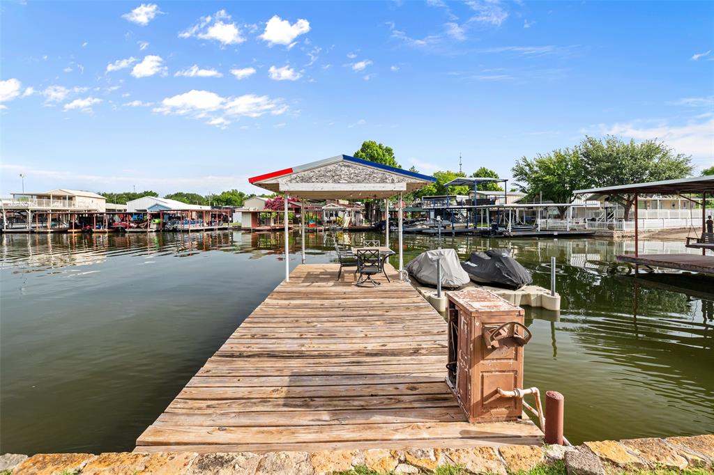 LETS MAKE A DEAL - MOTIVATED SELLER – Full-Time Living or Vacation Getaway, Just Minutes from Granbury's Historic Square!
Enjoy the best of lakeside living and small-town charm in this beautifully maintained 1,906 square foot double wide mobile home on Lake Granbury. Featuring 3 bedrooms, 2 full baths, formal and informal living rooms, a cozy fireplace, and a spacious layout, this home offers comfort and flexibility, perfect as a full-time residence or a relaxing vacation home.
Step outside to your private boat dock, ideal for fishing, a view of Granbury's famous July 4th fireworks show, or sipping tea while enjoying lake views. The property also includes a 2-car carport and an attached storage garage for all your lake toys and tools.
Located less than a mile from Granbury’s Historic Square, you’ll have easy access to charming shops, local dining, live entertainment at the Granbury Opera House, and year-round festivals. Just around the corner is Lake Granbury Beach, a family-friendly spot for swimming, picnics, and sun-soaked fun. 
This rare lakefront opportunity offers the ultimate combination of tranquility, recreation, and convenience—don’t miss your chance to make it yours!
All information to be verified by the buyer or buyer's agent.
