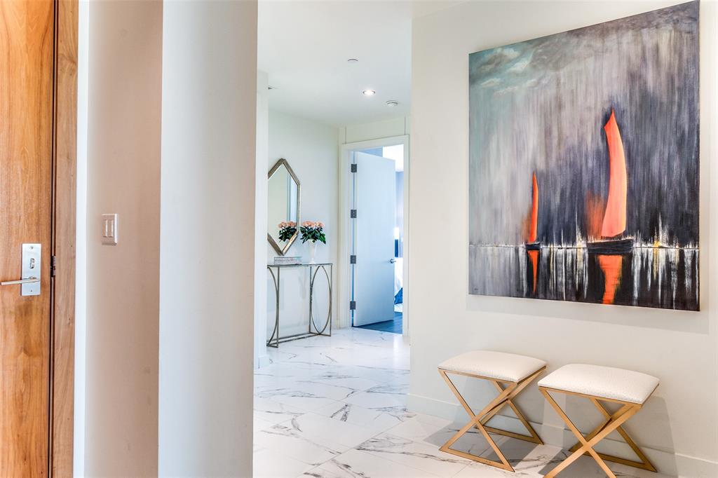 Extraordinary Azure unit with sweeping 21st floor downtown skyline views!  Two primary suites feature ensuite baths with dual vanities, tub, separate shower, and custom finished closet.  Primary suite one features a private balcony with a cozy fireplace. Primary suite two includes built-in upholstered headboard and bed, balcony fireplace.  Third bedroom is beautifully outfitted with built-ins and ensuite bath with shower and custom closet. Open living, dining and kitchen areas. Spacious kitchen with Meile gas cooktop, double oven and built-in coffee - espresso maker, Sub-Zero refrigerator and 130+ bottle wine refrigerator. Kitchen built-ins provide generous storage and work areas. Combined media pantry closet as well as spacious coat closet in entry. Recently updated Lutron shades throughout with remotes and wall controls. First floor, strategically  located four car garage (two double doors), with epoxy floor, built-in cabinetry with slat wall,  extra storage area within garage plus two separate storage lockers. Building amenities include valet, concierge, pool, outdoor kitchen, theater room, fitness center, business area and social room with caterer's kitchen.
