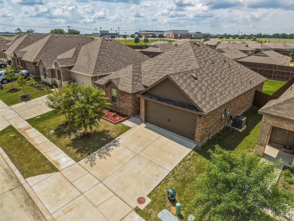Experience your dream home at 1210 Grand View Drive in Ennis, Texas! This charming 3-bedroom, 2-bath residence offers an inviting open floor plan that floods the living, dining, and kitchen areas with natural light, creating a warm and welcoming atmosphere perfect for entertaining or everyday living. The beautifully appointed kitchen features abundant cabinetry, generous counter space, and a large center island, making it the ideal gathering spot for family and friends.Retreat to the spacious primary suite, an oversized walk-in shower, and a sizable walk-in closet, providing both comfort and convenience. The additional bedrooms are generously sized, offering flexibility for guests, a home office, or growing needs.Step outside to your private backyard oasis, where you can unwind around the fire pit or enjoy the large covered patio, perfect for weekend barbecues and relaxation.Set in one of Ennis’ most desirable newer communities, this home is just minutes from Ennis High School, local shopping, dining, and everyday essentials, ensuring effortless living. For qualified buyers, a 2-1 lender-paid buy down is available, providing an excellent opportunity to secure a lower interest rate. Embrace the perfect blend of style, comfort, and modern convenience in this move-in ready home, where every detail has been designed for your enjoyment!