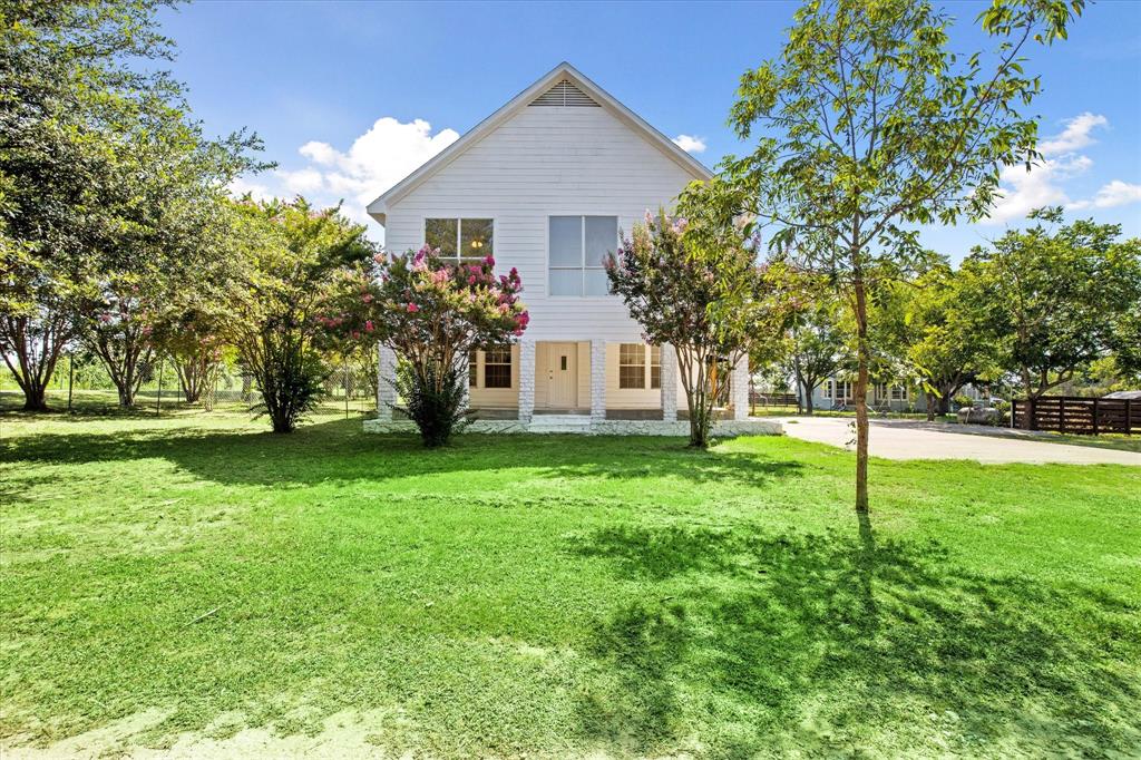 Escape the city to this charming farmhouse with room to roam on nearly an acre of land. Numerous updates including new HVAC, flooring, appliances, fixtures, paint, and more. The main level includes a cosy living area, large kitchen, walk-in pantry, primary laundry room, 2 bedrooms, and a large covered patio. Upstairs, the master suite has an additional laundry hookup for stackable washer and dryer and has a private balcony with stunning views, while 2 additional bedrooms and a living area provide ample space. The property includes a spacious outbuilding or shop, is fenced, and is on county water. Unleash your creativity both inside and out in this country retreat.