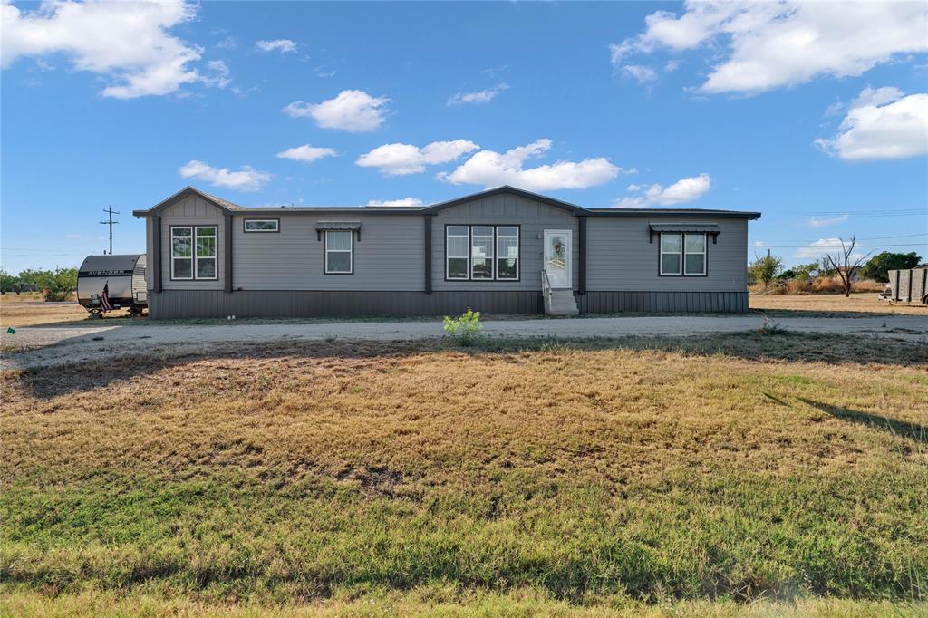 2023 Manufactured Double wide home. Welcome to a beautiful and modernly styled home offering 4-bedroom, 3-baths with an open floor plan, large kitchen island, walk-in pantry, and oversized laundry room. The primary suite offers dual walk-in closets and a luxurious bath with soaking tub and separate shower. The property features an existing water well (the home currently uses city water) and a RV hookup, making it a versatile home with endless potential! This property is settled on a double lot. Located within the Abilene metropolitan area, Anson provides residents with a tranquil rural setting while maintaining proximity to urban conveniences. Survey is available.