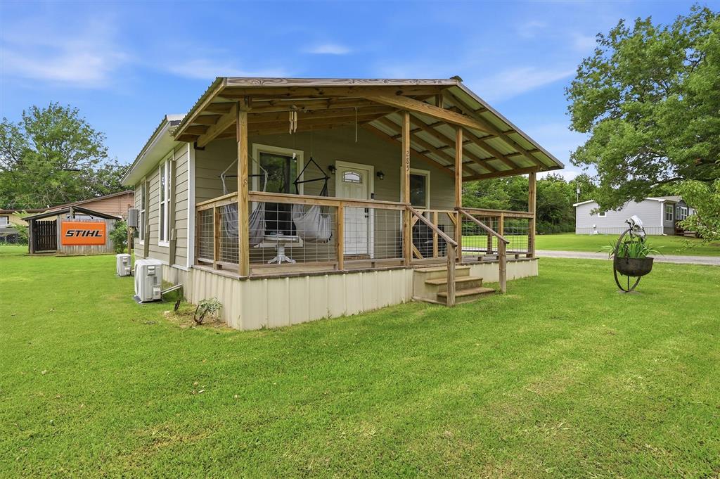 Nestled on a beautiful corner lot just minutes from Lake Texoma, this move-in-ready gem offers the perfect blend of comfort, style, and functionality. Relax and enjoy the outdoors from the spacious covered front and back porches. Then step inside to a welcoming living area that flows seamlessly into the recently remodeled kitchen. Thoughtfully updated, the kitchen features stunning granite countertops, a stylish tile backsplash, and newer appliances, creating a modern and inviting space for cooking and gathering. The home’s updates continue throughout with refreshed flooring and an updated bathroom, giving the entire property a clean, contemporary feel. Outside, you’ll find exceptional storage and workspace options, including a covered carport, an 18 by 24 metal building, and an additional 18 by 20 metal shop ideal for storing boats, vehicles, recreational equipment, or creating your dream workshop. Whether you’re searching for a peaceful lake-area retreat, a first home, or a property with plenty of room for hobbies and storage, this well-maintained home checks all the boxes. Conveniently located near Lake Texoma’s recreation, fishing, boating, and entertainment, this property offers the lifestyle you’ve been looking for.