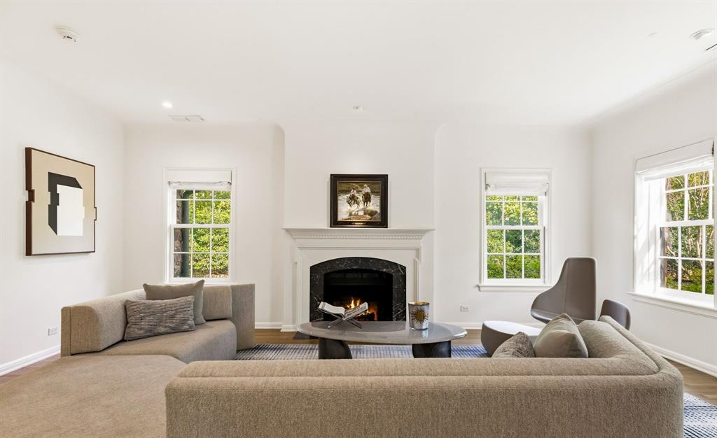 Exceptional Greenway Parks residence set on a 100-foot frontage lot backing to the greenbelt. Thoughtfully remodeled and expanded, this home honors its 1920s timeless charm while seamlessly incorporating modern updates. Recent improvements include a gracious new entry hall, fully renovated baths, the addition of a well-appointed caterer’s kitchen, and an expanded primary suite featuring a luxurious new bath and enlarged walk-in closet. A third bedroom suite has also been added, complete with spacious walk-in closets. This home showcases enduring architectural details, including smooth museum-finished walls, 9-foot coved ceilings, hardwood floors, and leaded glass windows. Subtle yet impactful enhancements to the floor plan, such as opening walls between living spaces and enhancing the sunroom with a wall of windows, create a light-filled environment ideal for effortless entertaining. Adjacent to the main kitchen, the caterer’s kitchen and laundry area offer exceptional functionality, featuring additional pantry storage, a second oven, microwave, refrigerator, and wine chiller. The property is further enhanced by extensive, beautifully designed landscaping.