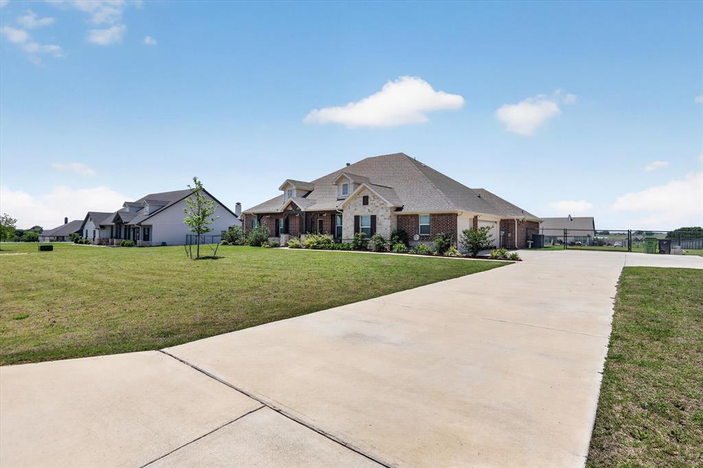 Set on a full acre in Godley, this beautifully designed 4-bedroom, 2.5-bath home offers the space, flexibility, and modern finishes today’s buyers are looking for while still keeping you conveniently connected to everything you need.

Inside, you’ll find a functional split-bedroom layout, dedicated office, and a separate media room. Perfect for working from home, entertaining, or everyday living. The open-concept main area features durable wood-look tile and flows seamlessly into a standout kitchen with a large quartz island, stainless steel appliances, custom cabinetry, and designer backsplash.

The private primary suite is designed for comfort with dual vanities, a soaking tub, separate shower, and a spacious walk-in closet. Secondary bedrooms are thoughtfully positioned for added privacy.

Step outside and experience what truly sets this property apart a fully fenced 1-acre lot with room to build, play, or expand. A poured 14x20 slab with attached 10x20 covered patio is already in place, ideal for a future shop, outdoor kitchen, or additional entertaining space.

Beyond the property, enjoy the convenience of being just a short drive to shopping, dining, and everyday essentials in nearby Cleburne and Burleson. With easy access to the Chisholm Trail Parkway, commuting to Fort Worth is simple making this home the perfect balance of country space and city accessibility.

Additional highlights include a 3-car garage, oversized laundry room with built-in storage, and the quiet, open feel that makes Godley one of the most desirable growing areas just outside Fort Worth.

If you’ve been searching for space, functionality, and a property that offers both privacy and convenience this one delivers.