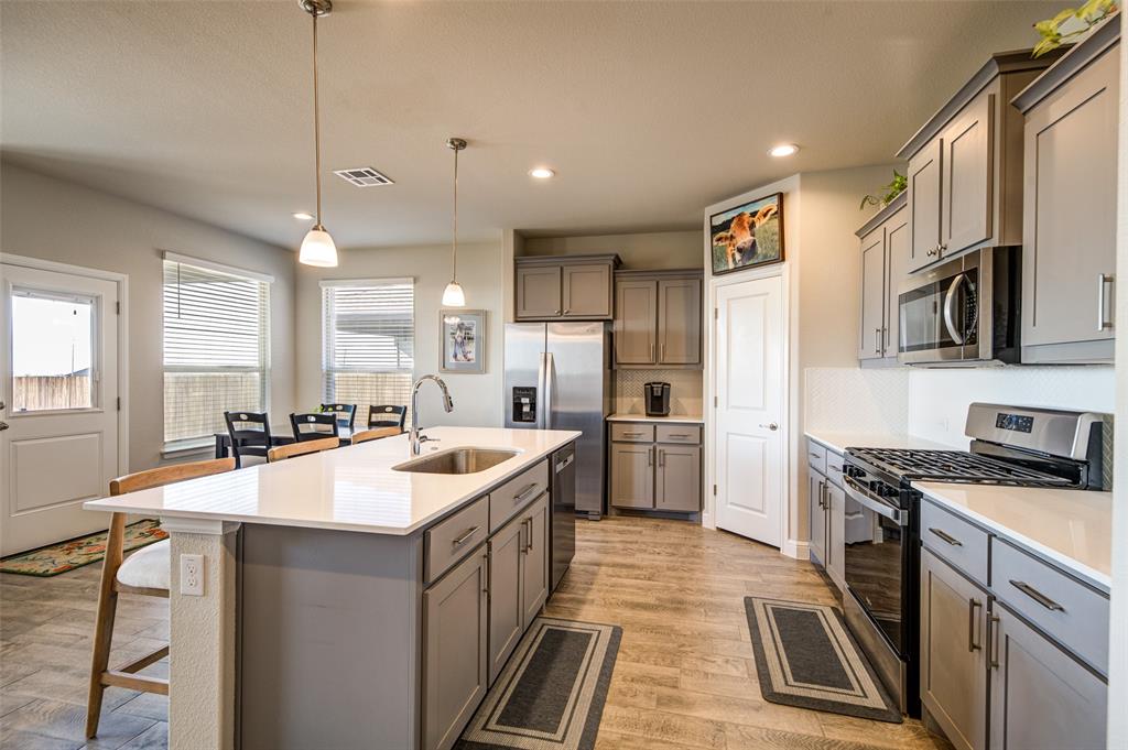 Just Reduced – Better Than New Smart Home with Community Amenities! Built in 2023, this beautifully maintained 4-bedroom, 2-bath smart home combines modern style, thoughtful upgrades, and energy-efficient features. Situated on an elevated lot, the property offers added privacy and attractive views.

The open-concept design seamlessly connects the kitchen, dining, and living areas, creating an ideal layout for everyday living and entertaining. The kitchen features soft-close cabinetry, custom hardware, and stylish finishes throughout. One secondary bedroom includes a custom built-in cabinet with shelving for added functionality and charm.

Energy-efficient upgrades include a tankless water heater and Lennox HVAC system for year-round comfort. Washer and dryer convey for added convenience. Exterior features include a sprinkler system and rain gutters.

Located in a growing community with convenient access to Fort Worth and DFW Airport, plus future nearby retail development planned. Residents enjoy exceptional neighborhood amenities including a community pool, playground, walking trails, and catch-and-release fishing pond. Move-in ready and priced to sell—this home offers the perfect blend of comfort, efficiency, and lifestyle.