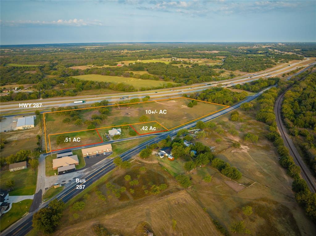 Unlimited opportunity with this cleared and ready to go 11-acre tract of land on the north side of Alvord, TX with 2 to 3 sides of road frontage and a blank canvas for building to suit or subdividing to capitalize on multiple lots. This property has 2 lots already re-zoned and platted with approved engineering plans for 7 townhouses on the north end of Alvord city limits. Fully engineered plans are included with the purchase. If desired, one could expand the townhouse footprint on a much larger scale across the remainder of the property. Having 4 or more 2+ acre lots is an option that could be more suitable for traditional commercial businesses.  The entire property is within the city limits and currently zoned for commercial use.  Access the property with ease from Business 287 or the 287 Bypass Rd. The longer side of the lot fronts the heavily travelled US-287 for maximum exposure to the thousands of drivers daily. The city is open to dividing the larger lot into smaller lots for businesses to thrive. The oil and gas well previously on the property has been plugged with all equipment removed making for a blank slate free of encumbrances to have to work around.
