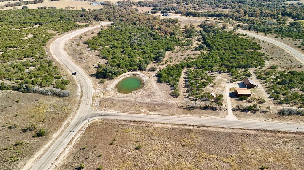 Sunrise Mountain Ranch, 2 or more Acre Lot with Sprawling Pond Views. Call Jordan  to view this property. - This one will go!! Listen, finding buildable land with NO floodplain and a sought-after water feature is tough these days. This lot overlooks the community's sprawling pond. Plus mature trees, killer views, and fiber internet already in the ground. What you need to know: Gated acreage lots, outside city limits, Build a barndo 1,400 sqft or tiny home - your call, Community pool, clubhouse, stocked ponds, 20 minutes to Stephenville, easy shot to Glen Rose Granbury. Why people buy here: Real country living without going off-grid. Work from home with fast internet. Watch the sunset over the water.