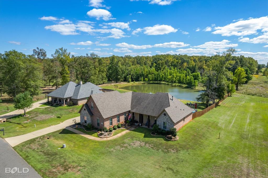 This is the one you've been waiting! Built in 2015 & sitting on 1.49 acres with a pond & a pool. This home truly has it ALL! 4 beds,2.5 baths with 2658 sq ft & office. Large living rm with brick fireplace & built-in cabinets that connects to a GORGEOUS custom kitchen. Ceramic wood tile floors throughout the entire downstairs. Granite counter tops for days with the massive island that has extra built in storage, 2nd sink, & 4 stool bar seating. Stainless steel appliances with gas range. Master bedrm with back patio access, dbl tray ceilings, & a stunning master bathrm suite with claw foot tub, oversized shower, & custom walk-in closet. 3 beds & 2.5 baths down. Upstairs is a large 4th bedrm or bonus rm. Talk about a back yard you will never want to leave. Large patio with built in cooking area that overlooks your custom pool that features a splash pad & waterfall. On chilly nights relax by the fire pit while looking out over your fully stocked pond. 3 car side entry garage. Must see!
