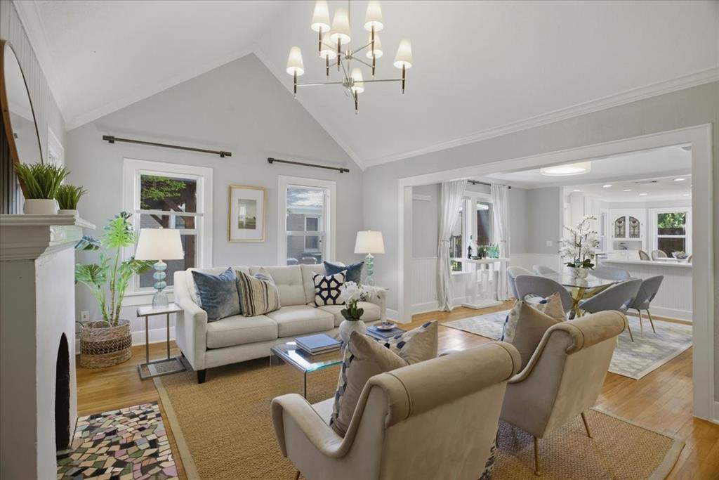 Charming Berkeley cottage featuring a welcoming front porch with iron railing. Step inside to a light-filled living room with vaulted ceilings, hardwood floors, and a decorative fireplace. The living, dining, and kitchen areas flow together, creating an open and comfortable layout.

The kitchen includes granite countertops, a gas range, breakfast bar, and a built-in corner cupboard. It overlooks the backyard, offering a pleasant view and easy access for entertaining.

The spacious primary suite features a large bathroom with a jetted tub, separate shower, double sinks, vanity, and heated floors. Two additional bedrooms share a hall bathroom.

Recent updates include recessed lighting and a deck off the back of the home. The private backyard features low-maintenance turf and an eight-foot wood fence for privacy.

This home combines classic Berkeley character with modern touches, offering comfortable living in a desirable location.