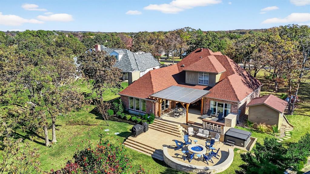 Summer will be here before we know it! Make sure you have a spot on the lake! This fabulous Lake Kiowa property is conveniently located between the main entrance and east gate. The backyard overlooks big water and the dam - just imagine those fireworks views on Fourth of July! The outdoor areas include an expansive deck with outdoor kitchen area, shaded patio area, and a fire pit with seating area. The two story boat dock with boat lift is another great spot to hang out and enjoy the views! Inside is a kitchen with loads of storage, a double oven, gas stovetop, lots of counter space and a breakfast bar. The living area has great views of the lake, a fireplace and is open to the kitchen. An adjoining room is currently used as a game room but could be a second living or formal dining room. There is also an office that can double as an additional bedroom. The primary suite is also located on the first floor. It features a large attached seating area overlooking the back yard and lake and a beautifully updated bathroom. Upstairs are two additional bedrooms and a bathroom. Don’t lose out on this fabulous opportunity to own a waterfront home in this fabulous community! Oh, did I mention that unlimited golfing is included in the low monthly POA dues?