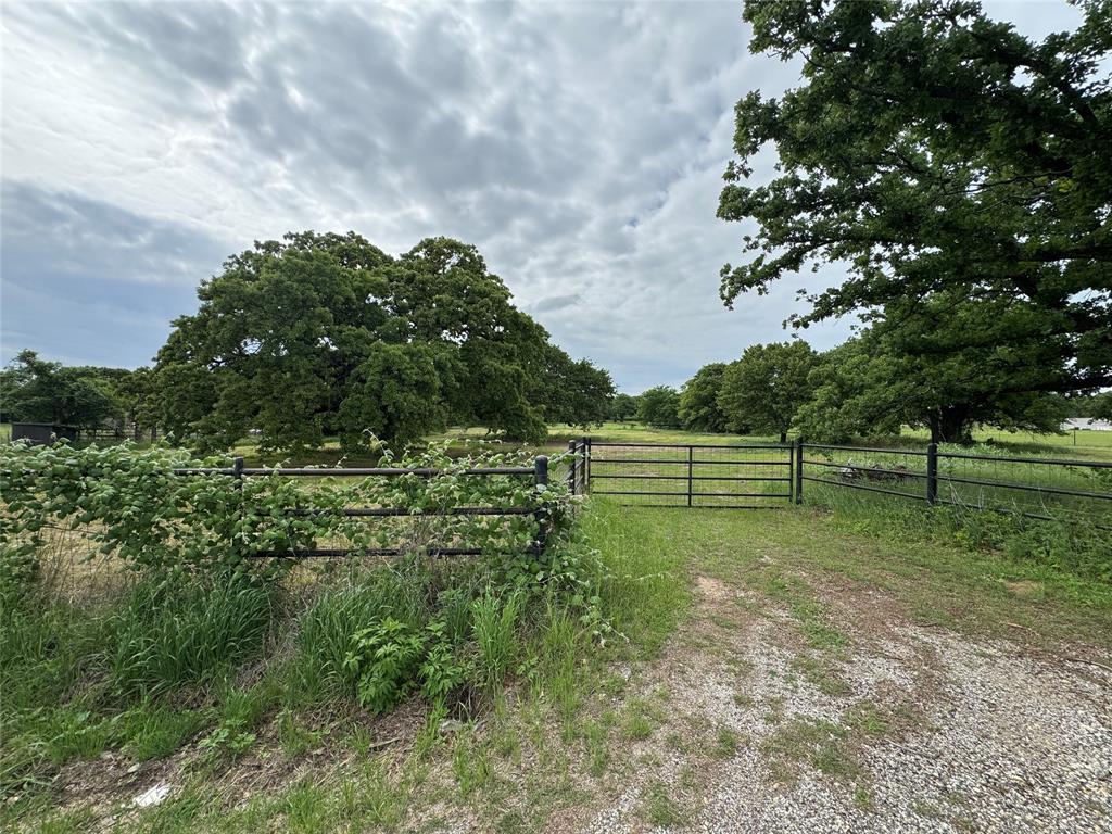 Fully fenced 2 acres with huge oak trees ready for your dream home. Has a water well, septic tank and a below ground tornado shelter from the original house.