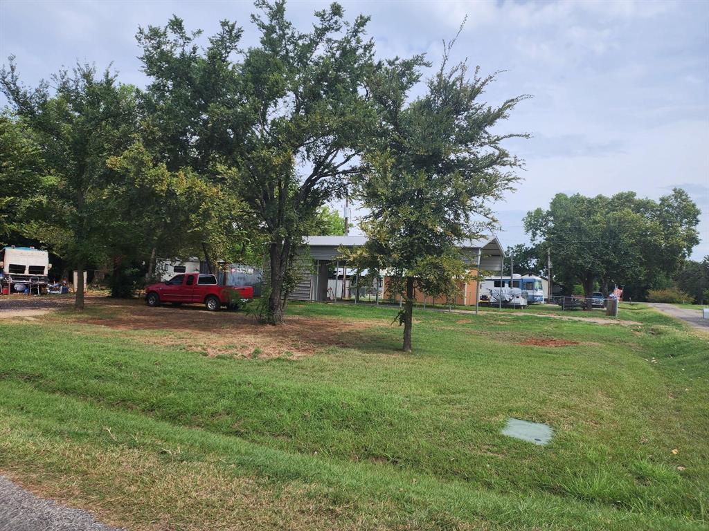 This corner lot is ready for your vision with electric, water, and septic already installed. A 20x50 RV cover sits on the property, offering the perfect setup for your own RV or the opportunity to generate income by renting space to others. Whether you choose to make it an income-producing property or transform it into your personal getaway by the lake, the options are wide open. Conveniently located near the Oklahoma border and just minutes from local casinos, you’ll also enjoy quick access to Lake Texoma with the Juniper Point boat ramp nearby.