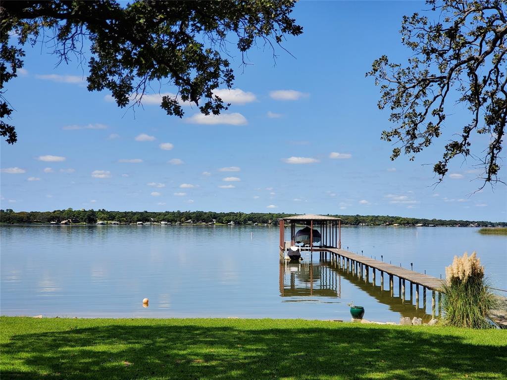 Cannot beat this LOCATION if you want a FUN neighborhood with great amenities and low ownership costs!  Beautiful WATERFRONT home on 1.4 acres with a boat dock and  open water views. Your own sandy beach! (see pic) Granite counter tops and stainless appliances. 3-2-3 +Office +Game room is only room upstairs. (either can be converted to 4th-5th bedroom) Covered porches. Tile flooring. High ceilings. Sprinkler system. Dock with lift. WBFP. High quality build with excellent attic-roof radiant barrier. Plenty of room to add more buildings. 

Fiber Optic Internet, Golf cart, ATV friendly neighborhood! 
BIG 3 car garage. 
Walk to neighborhood restaurant-bar and grill that has live music!
Low-traffic street.

When COMPARING remember: Built 2008 (most other waterfronts on this lake are much older) On EAST side of lake (closer to DFW & civilization). 

NO CITY TAXES, NO HOA, NO WATER BILL, NO SEWER BILL. 

DFW airport 45 minutes; Stockyards; Downtown Fort Worth 25 minutes; Alliance Area 25 minutes; BNSF 20 minutes. Major shopping areas 15 minutes.