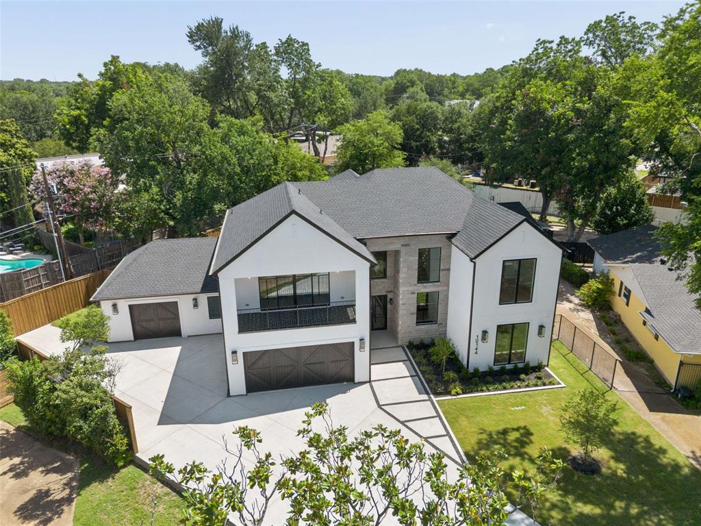 Welcome to this exceptional family home on a quiet cul-de-sac, minutes from the private school corridor.Outstanding drive-up appeal begins with the expansive lot allowing for 2 garages, a generous driveway and a grand walkway leading to impressive glass front doors.Step inside to light-filled open spaces! The spacious inviting living room is anchored by a sleek stone fireplace and warm natural wood built-ins. A glass-enclosed wet bar and conveniently located guest bath make entertaining effortless.Tucked away on the first floor, the 2nd bedroom with ensuite offers the perfect location for home office or guest retreat.The chef's dream kitchen is the heart of the home, and is as beautiful as it is functional. Abundant storage, sleek white quartz countertops, convenient pot-filler, and a suite of WIFI enabled GE Monogram appliances, including refrigerator make this kitchen ready for anything.Hidden behind pantry doors, is an extraordinary prep kitchen, complete with a second refrigerator, sink, microwave, dishwasher, cooktop and oven, and just beyond, an oversized walk-in pantry! Adjacent to the kitchen is the oversized mudroom that connects to the 2-car garage, the laundry room and the separate 1-car garage. Garages feature cedar-clad doors, epoxy floors and EV chargers. Spacious primary suite offers soaring ceilings and the perfect place to relax.The spa-inspired bathroom features a soaking tub, warm natural wood cabinetry, elegant finishes, and large walk-in closet.Outdoors, the covered patio showcases the warm wood-clad ceiling and a fully equipped outdoor kitchen opening to the expanse pool-sized yard.Upstairs 2 light-filled bedrooms with ensuites, flank a cozy play area or reading nook, and a third bedroom enjoys a separate wing. The spacious game room has a wet bar, and sliding glass doors to a covered balcony, perfect for family game night, movie night or entertaining.Convenient bath adjacent, is just another example of the builder's attention to every detail!
