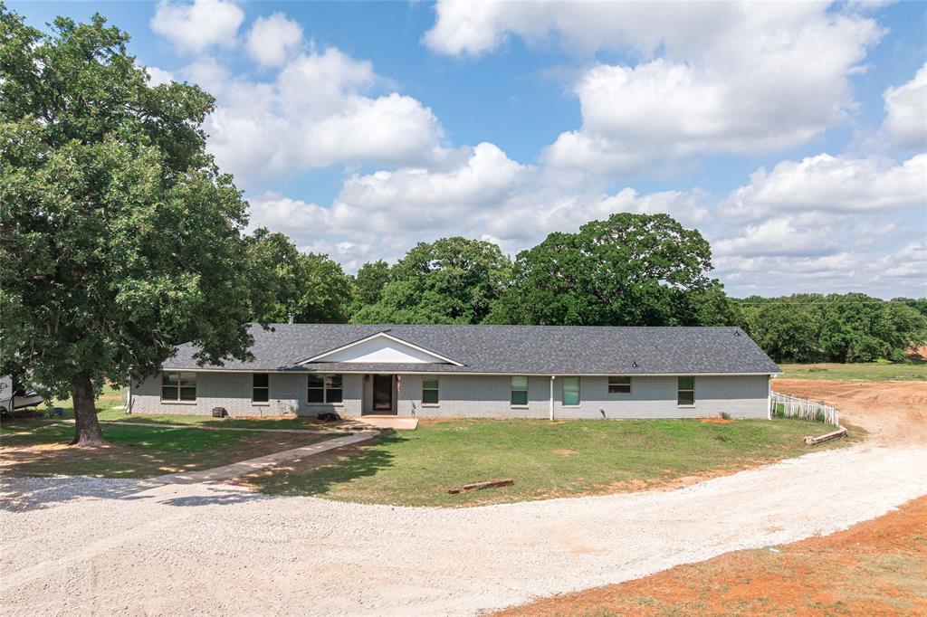 Experience the best of North Texas ranch living on just under 13 acres in highly desirable Whitesboro. This exceptional property features a beautifully maintained single-story ranch home offering more than 3,100 square feet of living space. Inside, you'll find stunning natural wood accents, a spacious, sensible layout, and a newly installed, level 2 roof. Designed for both relaxation and entertaining, property offers a spacious covered back porch perfect for entertaining family and friends while enjoying the peaceful country views. 
A separate living quarters complete with its own kitchen, living room, pantry, walk in closet, private entrance and a back porch, making it ideal for multi-generational living, guests, or potential rental opportunities.
The property has mature shade trees, rolling terrain, open pasture, and a picturesque, fully stocked pond teeming with a variety of fish species. Equestrian enthusiasts will appreciate the open-air riding arena and nature lovers will enjoy the abundance of fruit-bearing trees scattered throughout the property.
Additional improvements include four custom-built chicken coops, five bee hives, and two shipping containers that provide ample storage space. The sellers have also completed a foundation engineered to support a two-story building, perfect for use as a future barn or workshop, allowing the next owner to create the working facility of their dreams.
The property's agricultural exemption is maintained through the use of cattle, bee hives, and agricultural activities, providing valuable tax benefits while supporting a true ranch lifestyle.
Only a short drive north will bring you to Lake Texoma, where you will find an abundance of outdoor activities in or around the water.
Whether you're looking for a horse property, hobby farm, homestead, or private country retreat, this remarkable ranch offers the perfect combination of comfort, functionality, and natural beauty.
All information is reliable but not guaranteed.