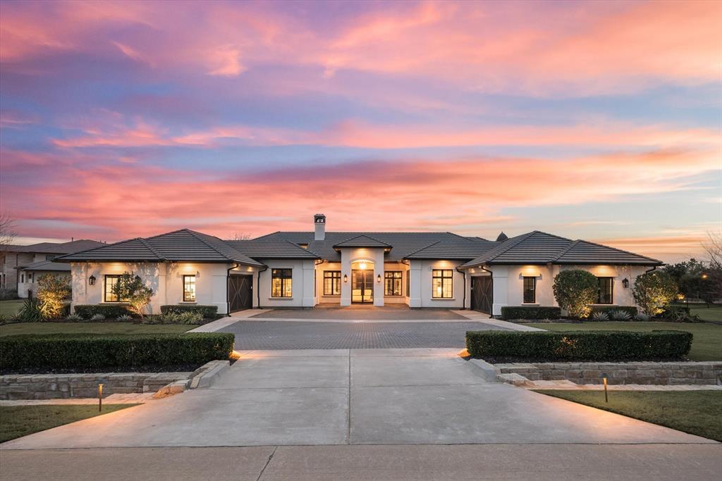The clean lines, natural light, and seamless flow of 1901 Versailles offer residents peaceful living in a luxurious setting. The center of the home is an open-concept living, dining, and kitchen area with its lovely ceiling and chandeliers. A separate workspace behind the kitchen provides a second refrigerator, sink, dishwasher, and ice maker. A glass wine closet divides the kitchen from the breakfast nook and uniquely displays one’s collection. The primary suite promises relaxation with its unique ceiling and spa-like bath. Soak in the cement tub or rinse off in the outdoor shower in the private courtyard just beyond. Four secondary ensuite bedrooms provide plenty of space for family and guests, one of which is a private suite with its own kitchenette and sitting space. A laundry room, exercise room, ample storage, and two two-car garages provide modern conveniences. And the stunning backyard, with its multiple patios and pool, invites you to play all year long.