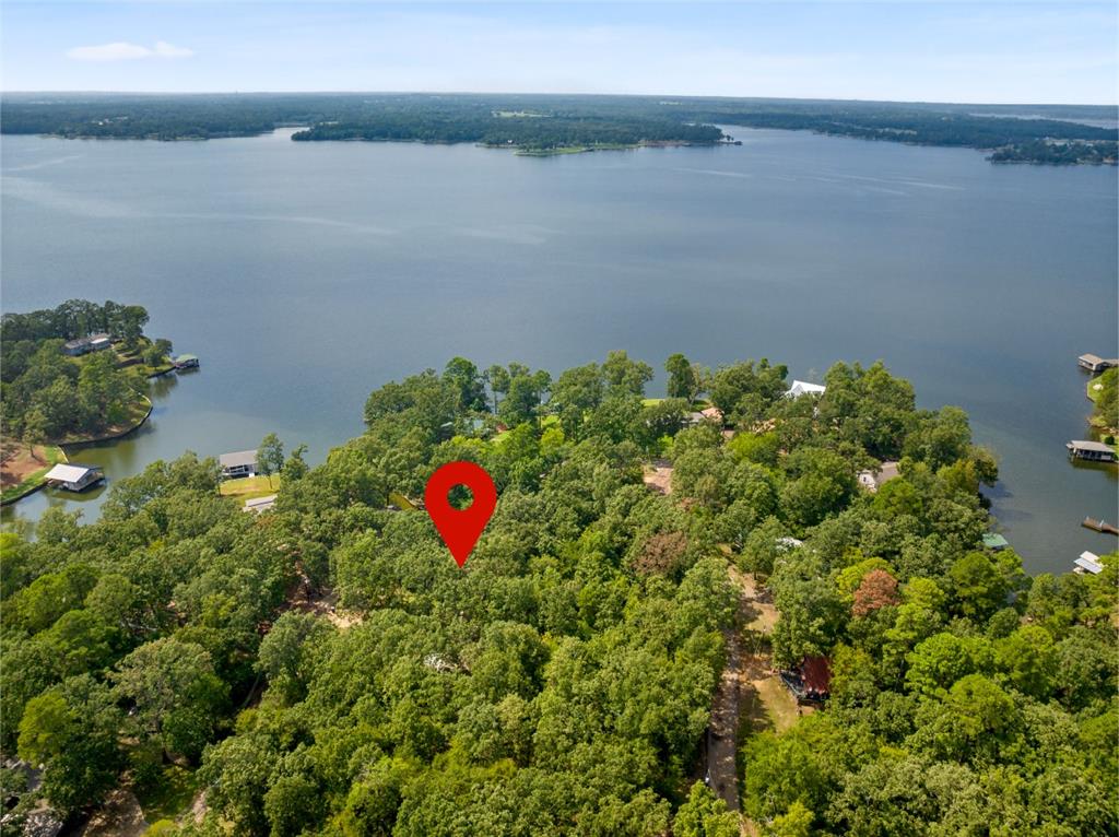 Welcome to your own retreat on the serene shores of Lake Bob Sandlin! This cozy 1 bed, 1 bath home is the epitome of lakefront living, boasting a spacious open living and dining area bathed in natural light from the floor-to-ceiling windows that offer stunning views of the lake. The kitchen is a chef's dream with ample cabinetry and modern appliances, including an electric range. The primary suite is a sanctuary with a luxurious ensuite bath featuring a soaking tub and a walk-in closet. Step outside onto the expansive deck, where you can unwind and savor the spectacular sunsets. Don't let this opportunity slip away - make it yours and embrace the tranquil lifestyle you've been dreaming of. Contact us now to schedule a viewing and seize your slice of paradise!