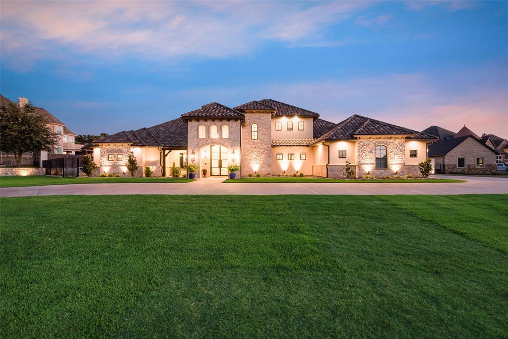Welcome to the 24 hr. gated & guarded Resort on Eagle Mtn. Lake! This immaculately kept, custom built, waterfront home is an entertainers paradise depicting elegance, class & luxury! You are welcomed by a circle driveway, impeccable landscape & curb appeal. Stunning iron doors & vaulted ceilings with picturesque views of the backyard & lake as you walk in. The master retreat is one of a kind, with a home gym, sauna, safe room, stunning master bath complete with an outdoor shower & oversized closet. The kitchen features a commercial grade fridge, gas cooktop, & beautiful iron doors to your butlers pantry. Three bedrooms downstairs with 3.5 baths. Upstairs has a bedroom, flex room, theater, & balcony overlooking the water. Pocket slider iron doors open the home to the backyard oasis. Infinity pool with spa, multiple seating areas, outdoor kitchen & living area built to entertain with 3 built in fire pits. An impressive list of upgrades that is too long to list as no detail was missed!