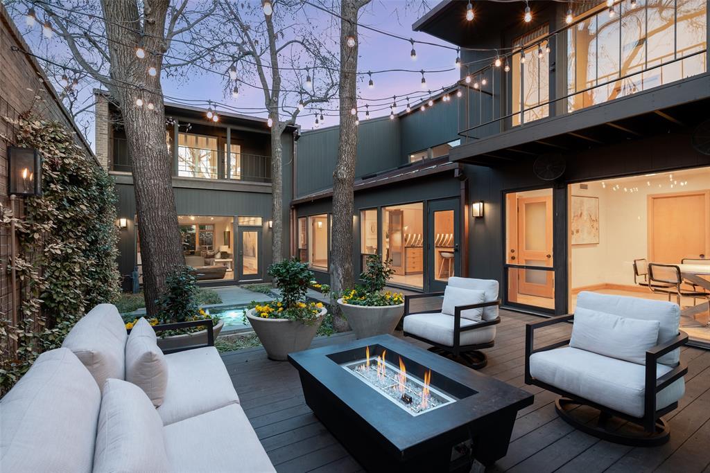 Architect-designed by acclaimed architect Bill Booziotis in the late 1970s, this distinctive residence blends timeless modern design, exceptional craftsmanship, and gallery-style living within a private Dallas enclave. Thoughtfully created for art collectors and sophisticated entertaining, the home features museum-quality lighting, expansive display walls, and dramatic floor-to-ceiling windows throughout the living, dining, and gallery spaces. A custom sculptural iron fence by renowned artist George Tobolowsky adds privacy and architectural character.

The serene central courtyard serves as an outdoor living retreat with in-ground water features, gas lanterns, and café lighting that create a warm ambiance for entertaining or relaxing evenings at home.

The spacious floor plan offers four upstairs bedrooms, including a luxurious primary suite with dual baths and balcony access overlooking the courtyard. A secondary bedroom also opens to a private balcony. The richly appointed den includes custom built-ins and a wet bar, while the kitchen features recently replaced appliances and opens to a light-filled breakfast room ideal for flexible living, office, studio, or library use, with an adjacent full bath.

Additional features include a heated and cooled gym, three-car garage with EV charging outlet, 60 kW whole-home generator, and architectural lighting throughout. Residents enjoy access to a community pool and tennis court within this limited-access neighborhood.

Ideally located near the Dallas North Tollway, Love Field Airport, premier shopping, dining, private schools, and major business corridors, 12 Royal Way offers a rare opportunity to own an architecturally significant home combining privacy, artistic living, and enduring design in the heart of Dallas.