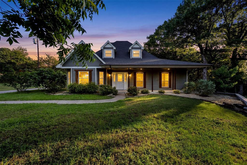 **Call & ask how you can lower your payments for the first year!** Situated on just over 2 scenic, tree-covered acres in the desirable Rutherford Crossing community, this stunning 5-bedroom, 3.5-bath home offers the ideal balance of space, comfort, and peaceful country living. The well-designed floorplan features multiple living and dining areas, decorative lighting, a spacious kitchen with an island and pantry, and a warm wood-burning fireplace perfect for gathering. The private primary suite creates a relaxing retreat, while the secondary bedrooms provide ample space for family, guests, or a home office. Enjoy quiet mornings or entertaining evenings on the covered patio overlooking the expansive backyard. Located in Palmer ISD with no HOA, this property delivers the serenity of country living while remaining conveniently close to Waxahachie shopping, dining, and major commuter routes. Come see this home today!!