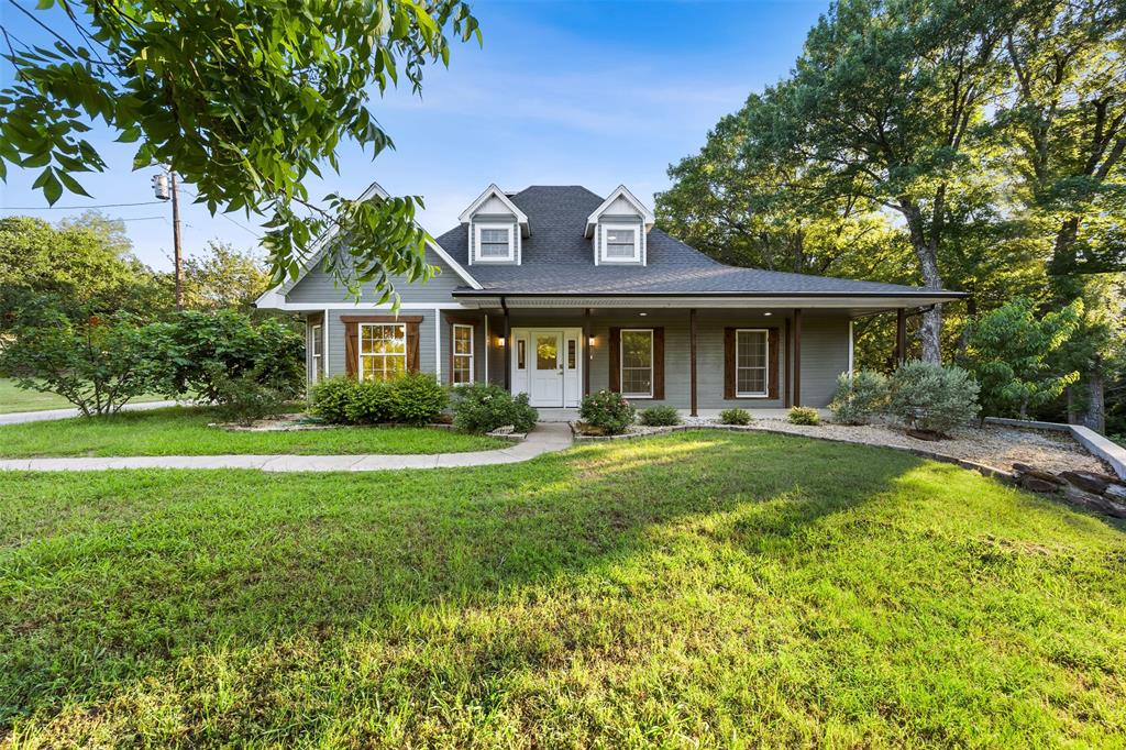 **Call & ask how you can lower your payments for the first year.** Situated on just over 2 scenic, tree-covered acres in the desirable Rutherford Crossing community, this stunning 5-bedroom, 3.5-bath home offers the ideal balance of space, comfort, and peaceful country living. The well-designed floorplan features multiple living and dining areas, decorative lighting, a spacious kitchen with an island and pantry, and a warm wood-burning fireplace perfect for gathering. The private primary suite creates a relaxing retreat, while the secondary bedrooms provide ample space for family, guests, or a home office. Enjoy quiet mornings or entertaining evenings on the covered patio overlooking the expansive backyard. Located in Palmer ISD with no HOA, this property delivers the serenity of country living while remaining conveniently close to Waxahachie shopping, dining, and major commuter routes.