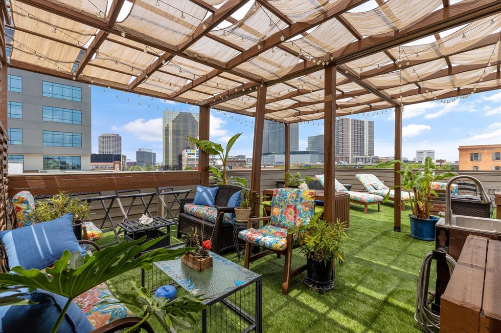 Are you a sports enthusiast? FIFA is coming!! Welcome to the ultimate LIVE, WORK, PLAY dream home in the heart of East Quarter, Downtown Dallas! Steps from the Dallas Farmers Market, incredible restaurants, and entertainment, minutes from Deep Ellum, the AA Center, West End, and Uptown, this home offers unbeatable access to everything that makes Dallas vibrant. With easy highway access and a location designed for those who thrive in the city's energy, this is your chance to own a piece of one of the hottest neighborhoods in town. 
This three-story brownstone townhome is the perfect blend of modern sophistication and urban convenience, offering 2,455 square feet of thoughtfully designed living space. With two spacious bedrooms, a versatile flex room, and two and a half baths, this home delivers the perfect balance of style, function, and flexibility.
Step inside to an open-concept second level, where the living room, dining area, and chef’s kitchen flow seamlessly together. High-end finishes, granite countertops, a gas cooktop, custom lighting, and an oversized island make this space perfect for entertaining. The primary suite spans the entire third floor, featuring a private sitting area, an ensuite bath with dual sinks, a soaking tub, a separate shower, and a massive WIC. The first level offers a guest suite with a full bath. The second floor has a corner room flex space that can serve as an office, workout area, or extra bedroom, complete with a a view of the East Quarter Red Bear!
One of the home’s most incredible features is the furnished 800-square-foot rooftop deck with breathtaking city views, offering the perfect backdrop for relaxing evenings or weekend gatherings. And yes—the rooftop furniture stays! Other bonuses include a two-car attached garage on a private street - plus 1 street parking at the front door, low HOA fees, and short-term rental-friendly policies, making this an excellent opportunity for homeowners and investors alike. New tankless w_h!