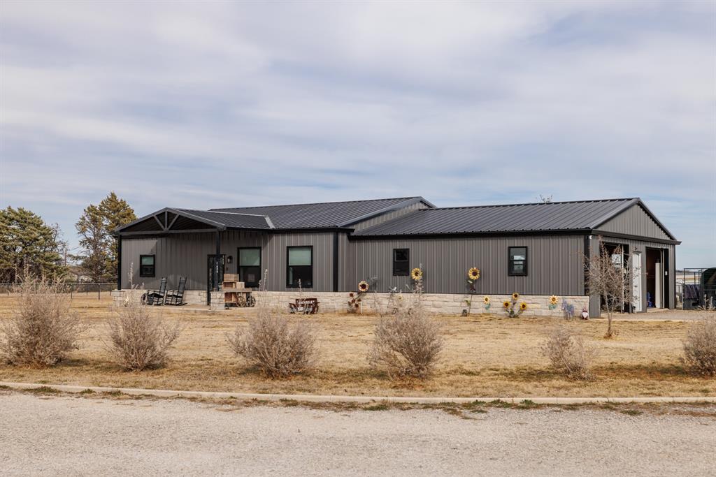 Set on 2.8 wide-open acres, this property offers space, comfort, and flexibility both inside and out. The main home features 2 bedrooms and 2 bathrooms with an open-concept layout designed for easy living. Durable LVP flooring runs throughout, paired with quartz countertops and a large kitchen that truly delivers—complete with a walk-in pantry and plenty of storage for everyday use or entertaining. Both bedrooms include private ensuite bathrooms, giving everyone their own retreat. Step outside to a covered back porch made for relaxing or hosting, highlighted by a large stone fireplace overlooking the backyard. Just beyond, enjoy an in-ground pool with a tanning ledge—perfect for warm days and laid-back evenings. Adding even more value is a large shop with electricity and an attached apartment. The apartment includes 1 bedroom, 1 bathroom, and an open kitchen and living area, making it ideal for guests, extended family, or rental potential. With acreage, multiple living spaces, and great outdoor amenities, this property offers room to spread out and endless possibilities.
