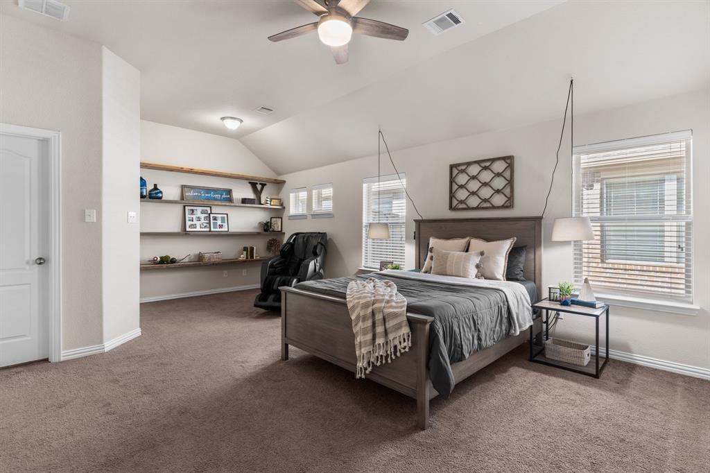 Exquisite single-story, energy-efficient home in the master-planned community of Trinity Falls in North McKinney. Lush trees and manicured landscaping frame the striking brick and stone façade, highlighted by a distinctive herringbone detail and elegant copper window awning, while an arched entry leads to the inviting brick front porch complete with a Ring doorbell and keyless entry. Inside, a dramatic circular foyer with tray ceiling sets the tone. Engineered wood floors flow throughout the main living areas. A versatile front bonus room—ideal as a home office, media, or game room—is wired with a Denon smart-home sound system for listening to music or watching the big game with surround sound. The private primary suite, accessed through French doors, features vaulted ceilings, four sunlit windows, custom built-in shelving, a sitting area, and two generous walk-in closets. End a long day in the spa-inspired bathroom, which offers dual sinks with granite countertops, a soaking tub beneath a large window, a walk-in tile shower with body spray, and a private water closet. Enjoy cooking and baking in the eat-in kitchen that boasts white cabinetry with deep drawers for pots and pans, granite countertops, tile backsplash, walk-in pantry, and an island with undermount dual sink and upgraded pull-down faucet. Host dinner parties or family meals in the light and bright dining area and gather your loved ones in the cozy living room, anchored by a gas fireplace and vaulted ceilings, with patio access for seamless indoor-outdoor living. The covered patio is an entertainer’s dream, showcasing a vaulted pine ceiling with fan, in-ceiling speakers, and gas stub in place for outdoor grilling. A spacious backyard with grassy play area completes the setting. Community amenities include pools, ponds, dog park, pickleball, playgrounds, Frazier Elementary, and easy access to Hwy 75.