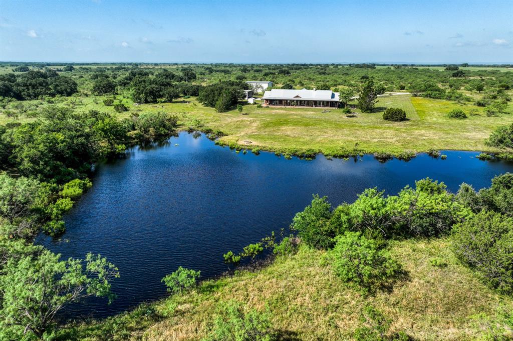 Welcome to Rock House Ranch, a luxurious 175-acre retreat in Callahan County. This breathtaking property features a stunning main home and a separate guest house. The lodge-style main home boasts an open concept design with 16-foot ceilings, a magnificent rock fireplace, and abundant natural light. It includes 3 bedrooms, 2 baths, a butler's kitchen, and an office convertible to a fourth bedroom. The master suite offers walk-in closets, a stone-featured garden tub, and a covered porch with panoramic views. The grounds are meticulously maintained with fruit trees, a stocked fish tank, and abundant wildlife.

Highly energy-efficient and equipped with city water and fiber-optic internet, the property also features a one-bedroom guest house, ample covered parking, a 40x50 foot foam-insulated barn, and facilities for large vehicles like RVs. Perfect for hunting with deer, turkeys, quail, doves, and hogs, Rock House Ranch is a turn-key sanctuary blending luxury with nature.  Drone views