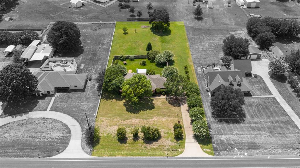 THIS IS A STEAL & PRICED UNDER TAX APPRAISED VALUE FOR 1 ACRE IN MIDLOTHIAN ISD!! NO HOA!! NO CITY TAXES!! Don’t miss this 3 BEDROOM, 2 BATH, 2 CAR GARAGE home sitting on ALMOST AN ACRE just outside the city limits, an unbeatable location in the sought after MIDLOTHIAN ISD! Both the front yard and backyard are HUGE, with a portion of the backyard enclosed by a PRIVACY FENCE and even more yard space beyond it. A GARDENER’S DREAM, the grounds feature many beautiful MATURE TREES including oaks, cypress, and crape myrtles, along with multiple rose bushes. Relax on the COVERED BACK PORCH with a ceiling fan, or entertain on the COVERED FLAGSTONE PATIO with outdoor lighting. Inside, a spacious open living room welcomes you with TALL CEILINGS, CANNED LIGHTING, and a cozy WOOD BURNING FIREPLACE. The formal dining area boasts a HUGE BAY WINDOW, perfect for family gatherings. The large eat in kitchen features CERAMIC TILE FLOORS, COUNTERTOPS, AND BACKSPLASH, a small breakfast bar leading into the breakfast room, DECORATIVE TILE CEILINGS with ornate lighting, and elegant TWO TONE PAINTED WALLS are complemented by DECORATIVE CHAIR RAIL MOLDING with OVERSIZED WHITE TRIM.  CROWN MOLDING and TRAY CEILINGS throughout the house that add architectural character and warmth. GENEROUS WALK IN CLOSETS are found throughout, including TWO LARGE HIS AND HERS WALK IN CLOSETS in the primary suite. The primary bathroom is a true retreat with a HUGE JETTED TUB, decorative chandelier, and TRAY CEILING. Additional character touches include BUILT IN CABINETS in the hallway. This home has strong bones and all the perks of county living, including NO HOA!!! PRICED TO SELL, this one won’t last!