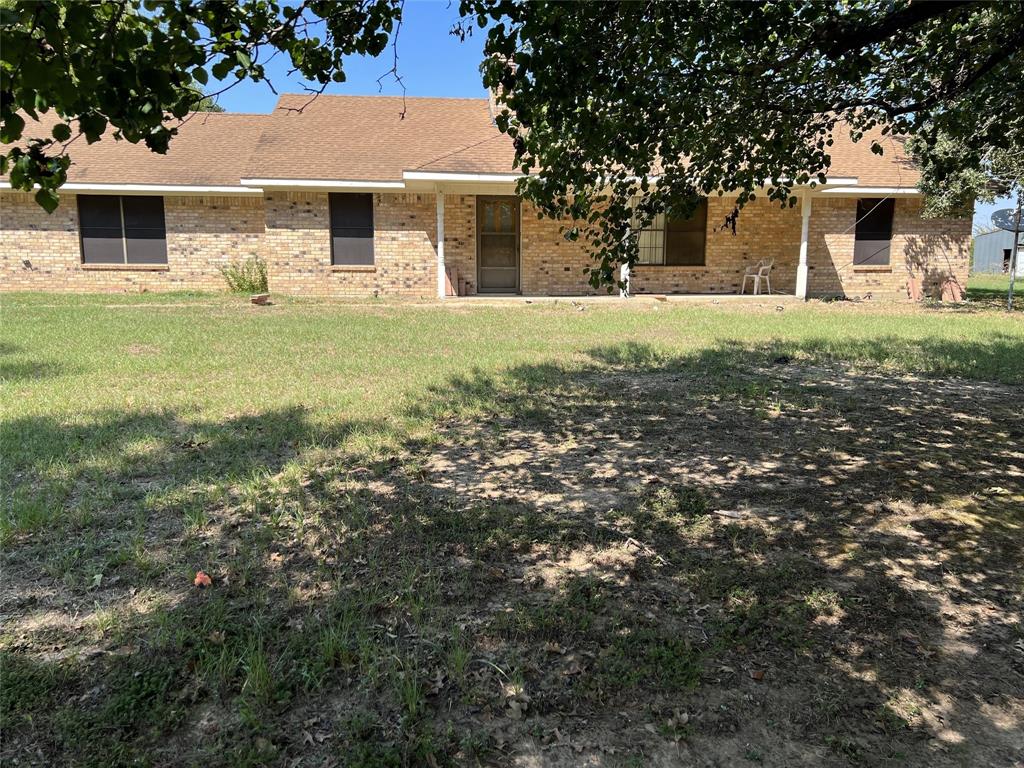 This spacious 4-acre property boasts a 2,400 sq. ft. commercial building featuring multiple overhead doors, plus RV-sized door. A generous 1,750 sq. ft. detached garage, with two overhead doors and an entry door, and a 720 sq. ft. storage building.  In addition, two carports provide ample covered parking options. The land is partially fenced for livestock, situated on a corner lot with frontage on FM 859, offering excellent proximity to HWY 80 and Hwy 19, ensuring a convenient commute to Dallas and Tyler. The property is adorned with numerous large trees. The house on-site is a renovation project, part of an estate sale, and will be sold AS IS. It features a primary bedroom separate from secondary bedrooms, a fireplace with insert, a covered porch, and a spacious covered patio. Additionally, the side entry attached 2-car garage completes this versatile property, perfect for various residential and commercial possibilities.